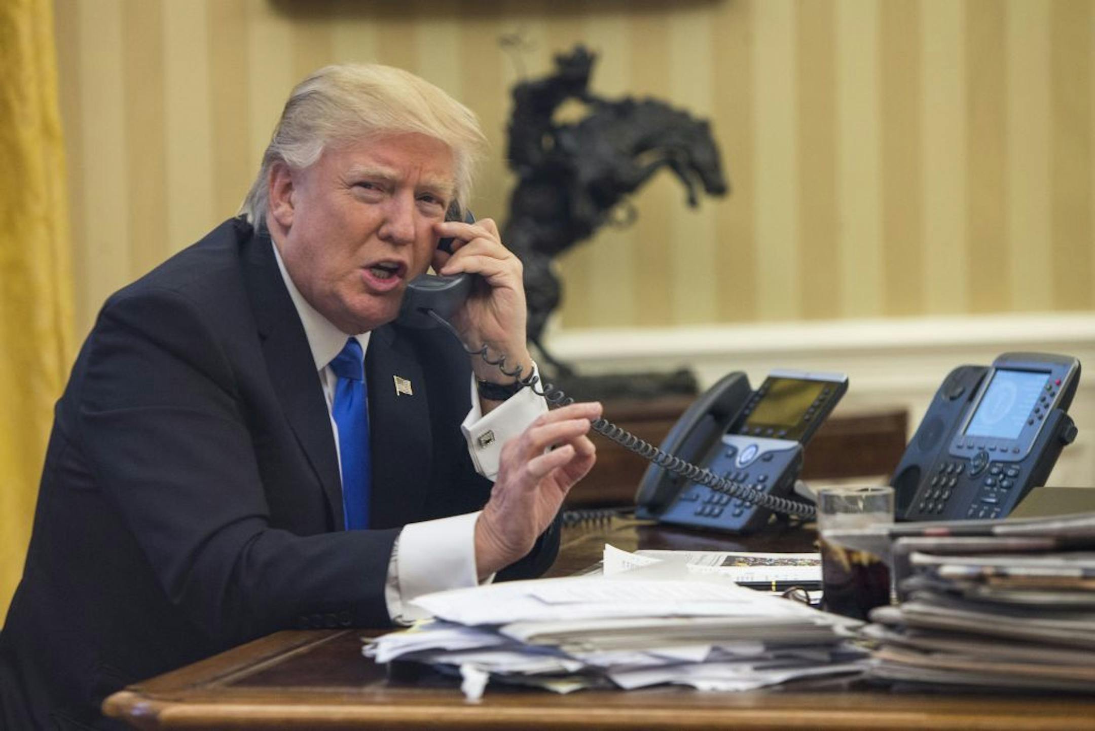 FILE -- President Donald Trump speaks by phone with Prime Minister Malcolm Turnbull of Australia, at the White House in Washington, Jan. 28, 2017.
