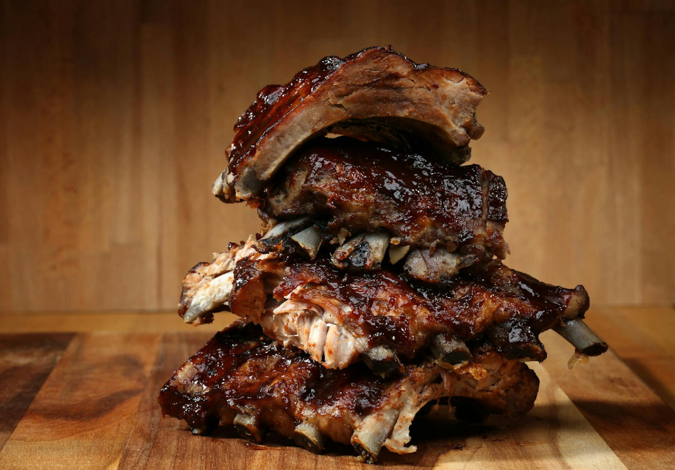 Slow-grilled ribs are coated at the end with a sweet and smoky sauce spiked with bourbon.