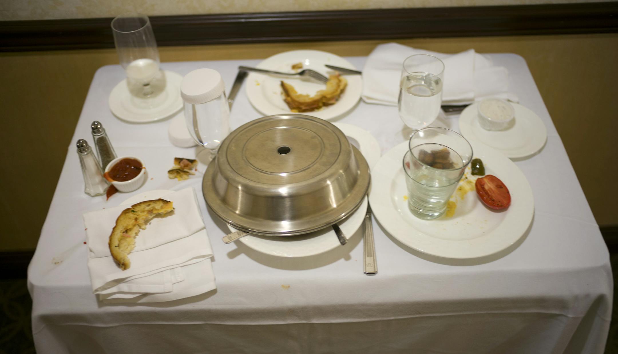 A cart with finished room-service orders at the New York Hilton Midtown, June 2, 2013. In August, the hotel will discontinue food and drink service to all 2,000 of its rooms; in its place will be a new cafeteria-style restaurant that will be stocked with grab-and-go items. (Robert Caplin/The New York Times) ORG XMIT: MIN2013061911092259