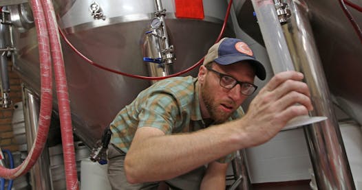 Tom Whisenand, co-owner of Indeed Brewing, works his magic.
