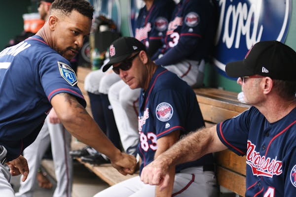Twins outfielder Byron Buxton (25) fist bumped Twins manager Paul Molitor. During spring training, road teams are expected to field lineups with at le