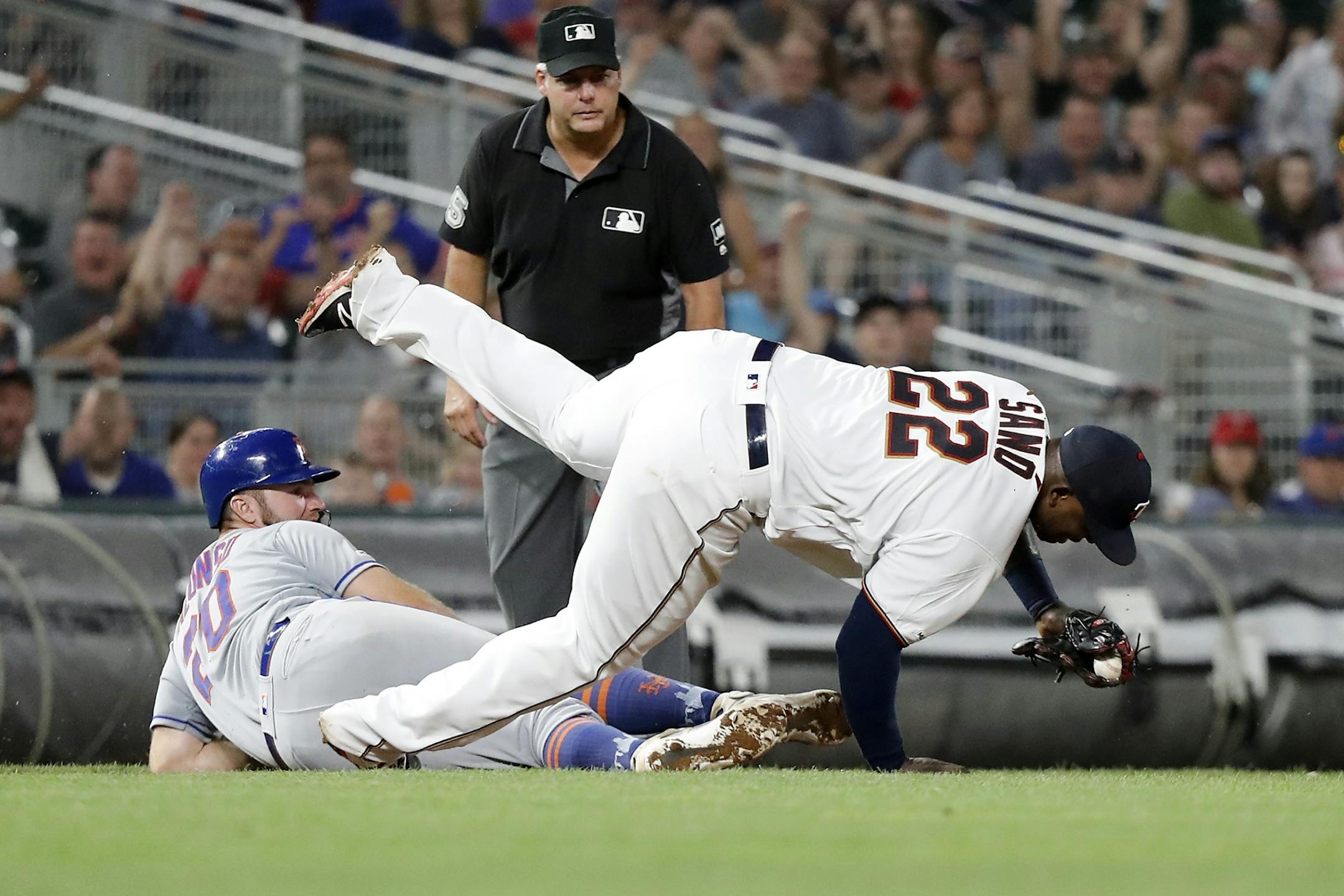 Minnesota Twins third baseman Miguel Sano (22) tags out New York Mets first baseman Pete Alonso (20) at third base for a double play in the eighth inning.
