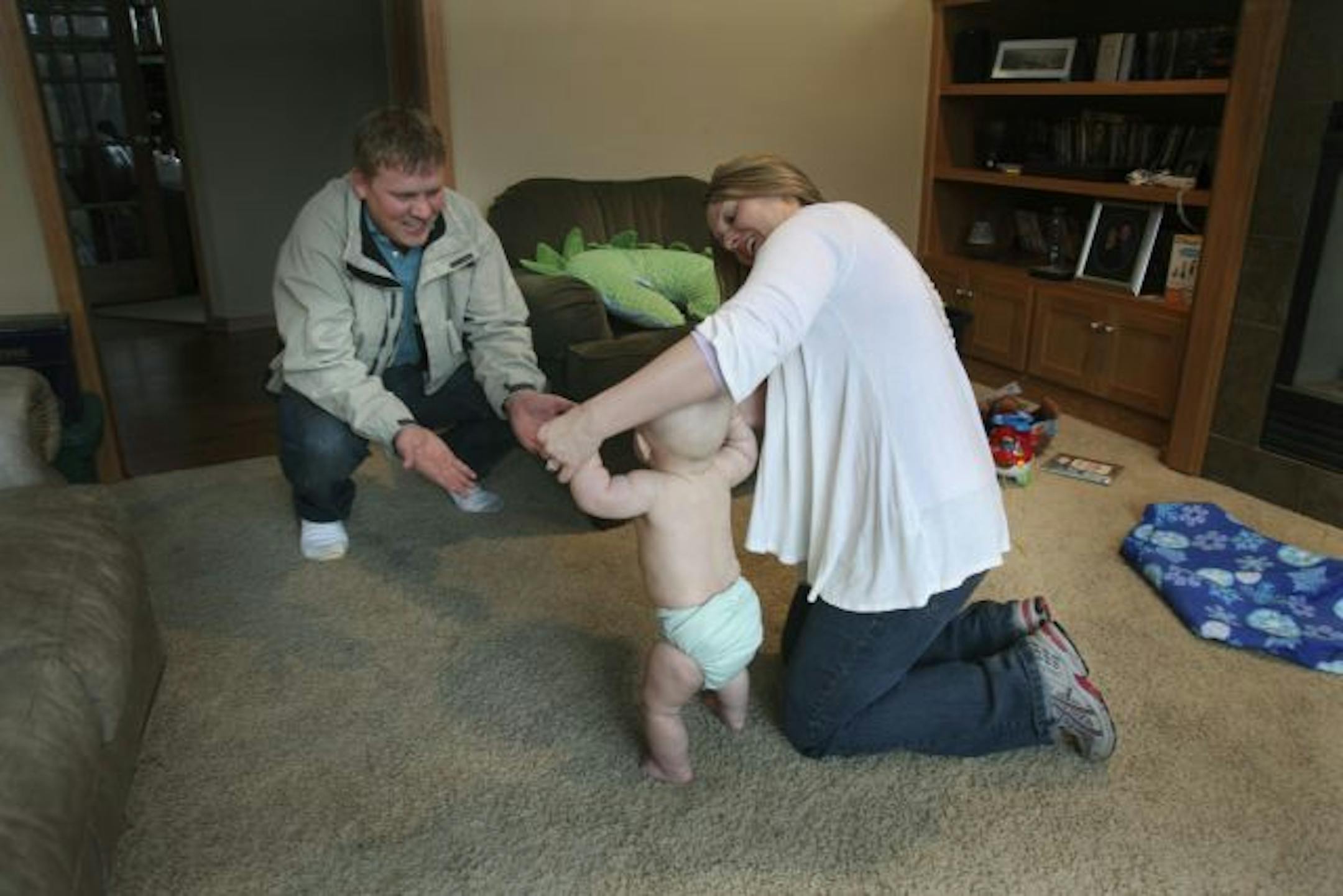 Martin Cross greeted a happy customer, Logan Schneider, and his mother, Kristi Schneider. Cross and his wife, Patti, run All Things Diapers out of their home, laundering diapers in industrial-strength washers and dryers in their basement. Their business is growing; about 12 expectant parents are signed up.