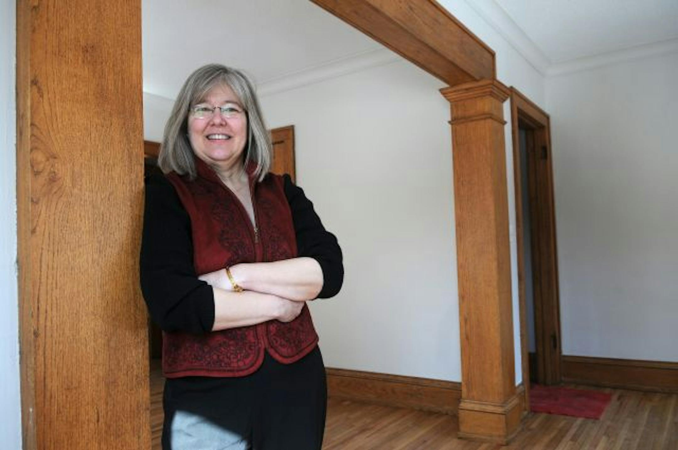 Lee Blons, executive director of the Plymouth Church Neighborhood Foundation, stands ina first floor studio apartment.