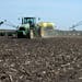 A Deere & Co John Deere 8130 tractor pulls a 24-row planter as corn is planted in Malden, Illinois, U.S., on Tuesday, May 6, 2014. This year's record 