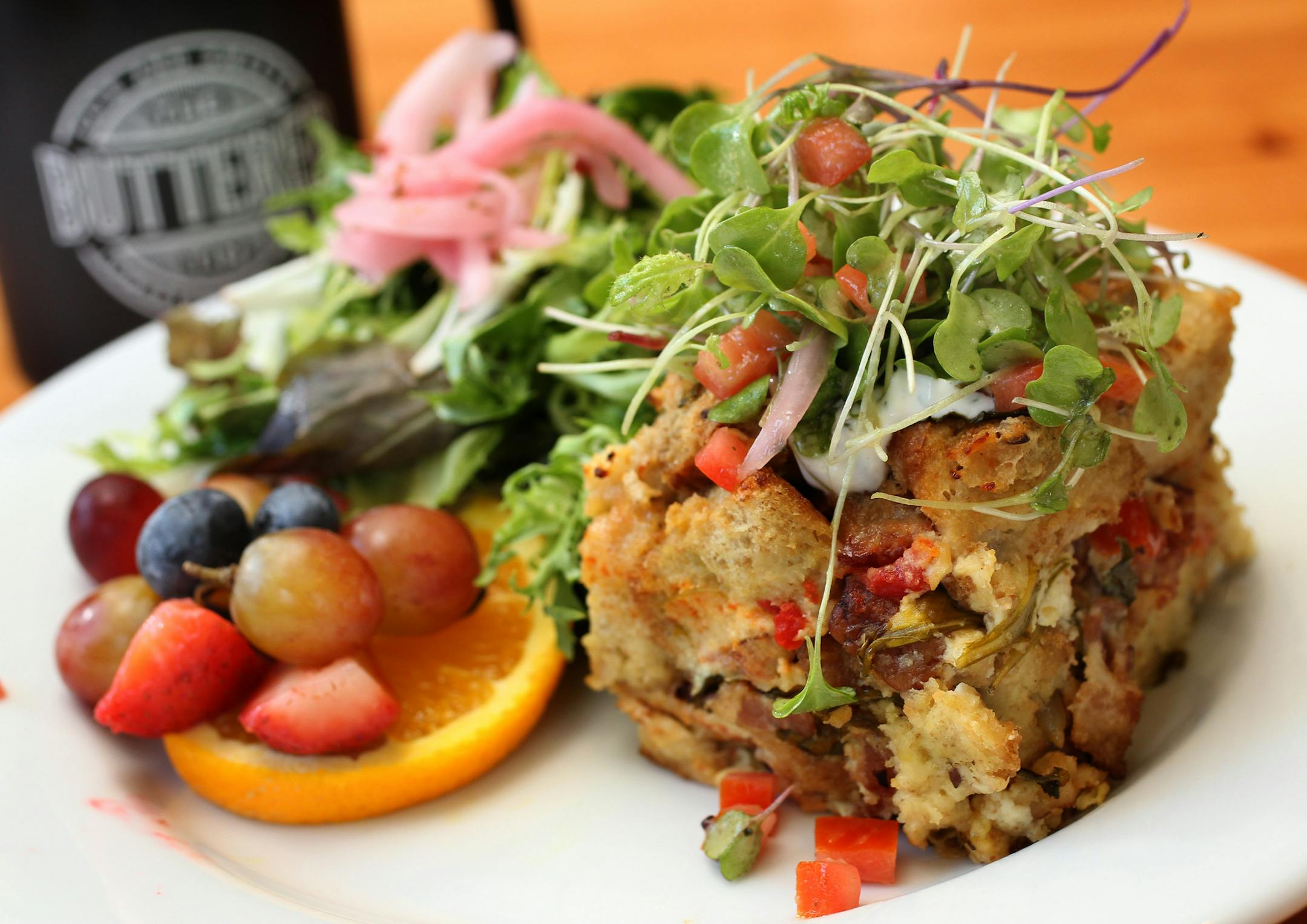 The breakfast "hot dish." ] STAR TRIBUNE/TOM WALLACE Assignments #20029971A July 19, 2013 SLUG & MAGIC SAXO#: 490032 rn072513 EXTRA INFO: Two new St. Paul bakery/cafes. The Buttered Tin, co-owners Jennifer Lueck and Alicia Hinze, and the Food: French toast, breakfast "hot dish," tomato soup, chicken club sandwich, Twinkies and HoHo pastries, and a sliced sweet breads on the counter.