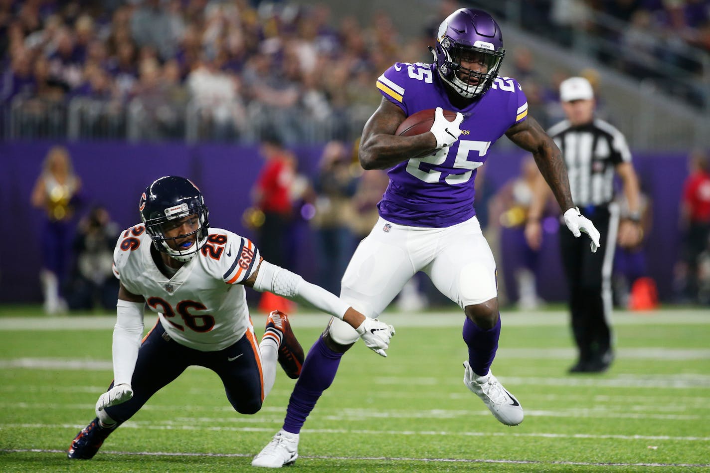 Minnesota Vikings running back Latavius Murray (25) runs from Chicago Bears defensive back Deon Bush, left, during the second half of an NFL football game, Sunday, Dec. 30, 2018, in Minneapolis. (AP Photo/Bruce Kluckhohn)