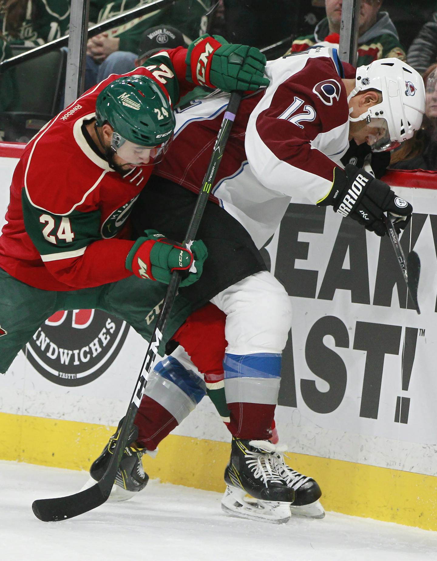 Colorado Avalanche right wing Jarome Iginla (12) and Minnesota Wild defenseman Matt Dumba (24) battle for the puck along the wall during the second period of an NHL hockey game Saturday, Nov. 19, 2016, in St. Paul, Minn. (AP Photo/Paul Battaglia)