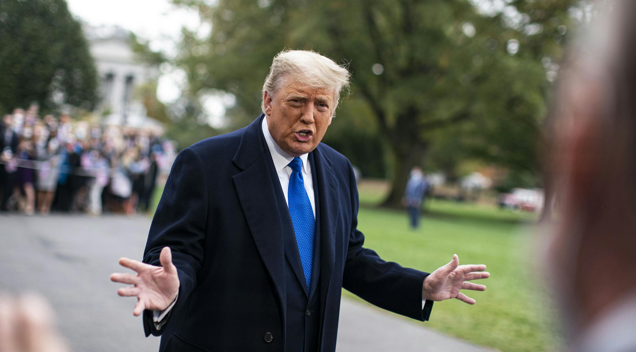President Donald Trump speaks to reporters before boarding Marine One on the South Lawn of the White House in Washington, on Tuesday, Oct. 27, 2020. Trump is traveling to Michigan, Wisconsin, Nebraska, and Nevada. (Al Drago/The New York Times)