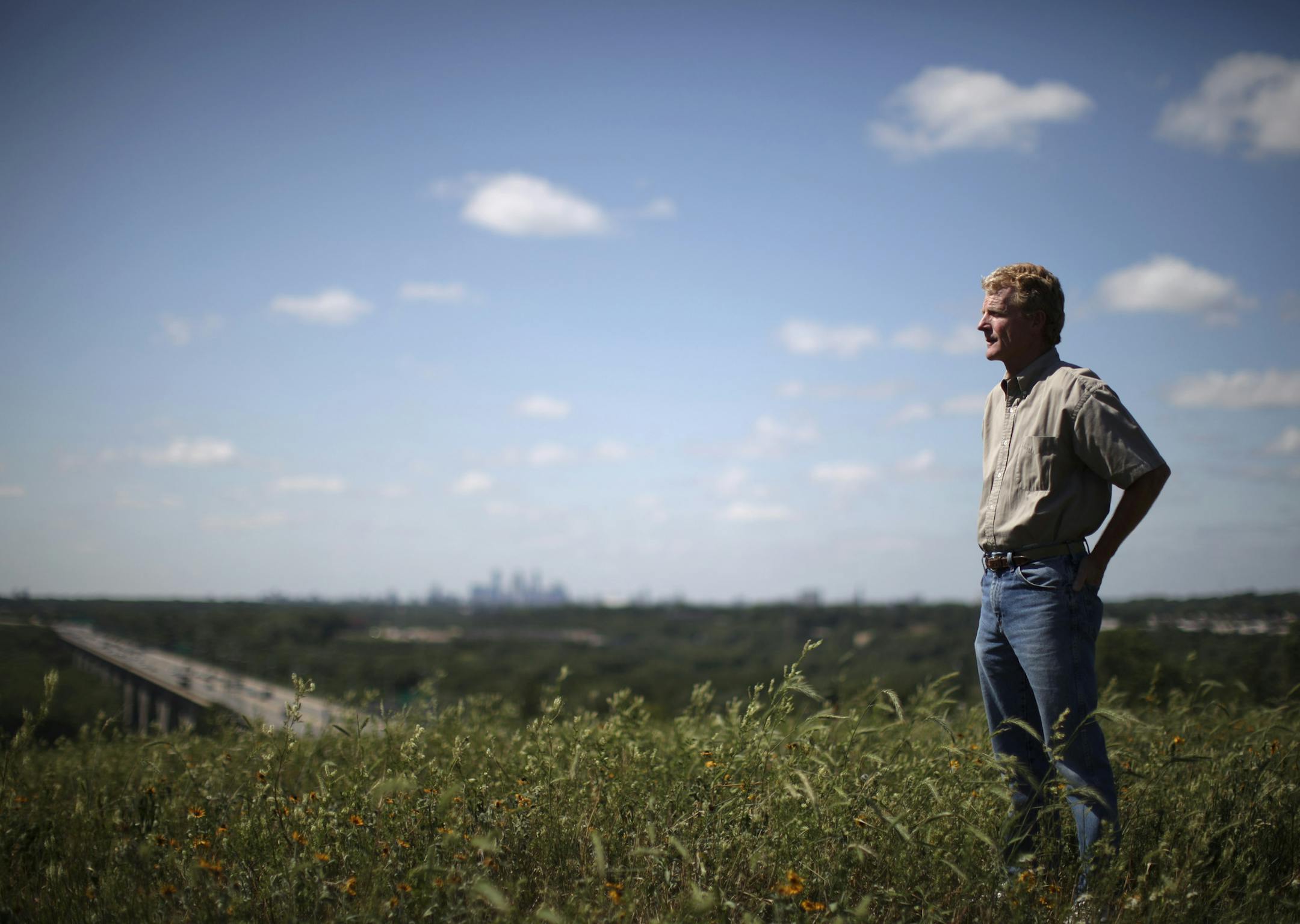 JEFF WHEELER • jwheeler@startribune.com MINNEAPOLIS - 7/15/09 - State Archaeologist Scott Anfinson is an expert at identifying sacred Indian burial sites. IN THIS PHOTO: ] State Archeologis Scott Anfinson stands atop Pilot Knob in Mendota Heights Wednesday afternoon. He identified the site as an Indian burial site, ultimately halting development of the land across the river from the site of the first white presence in the area, Fort Snelling, and the later, much larger development –