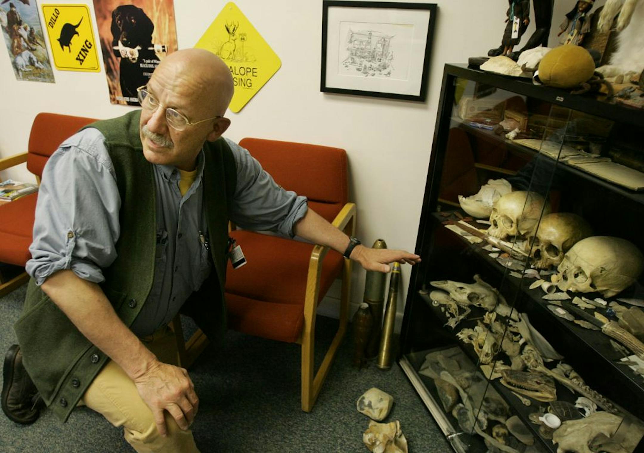 Dr. Tim Lepore, of Nantucket, Mass., displays a collection of bones, including some sculls, in the waiting room of his office at Nantucket Cottage Hospital, Wednesday, June 8, 2005.
