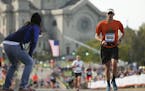 Chad Millner of Eden Prairie received encouragement from a race official just shy of the finish line Sunday morning.