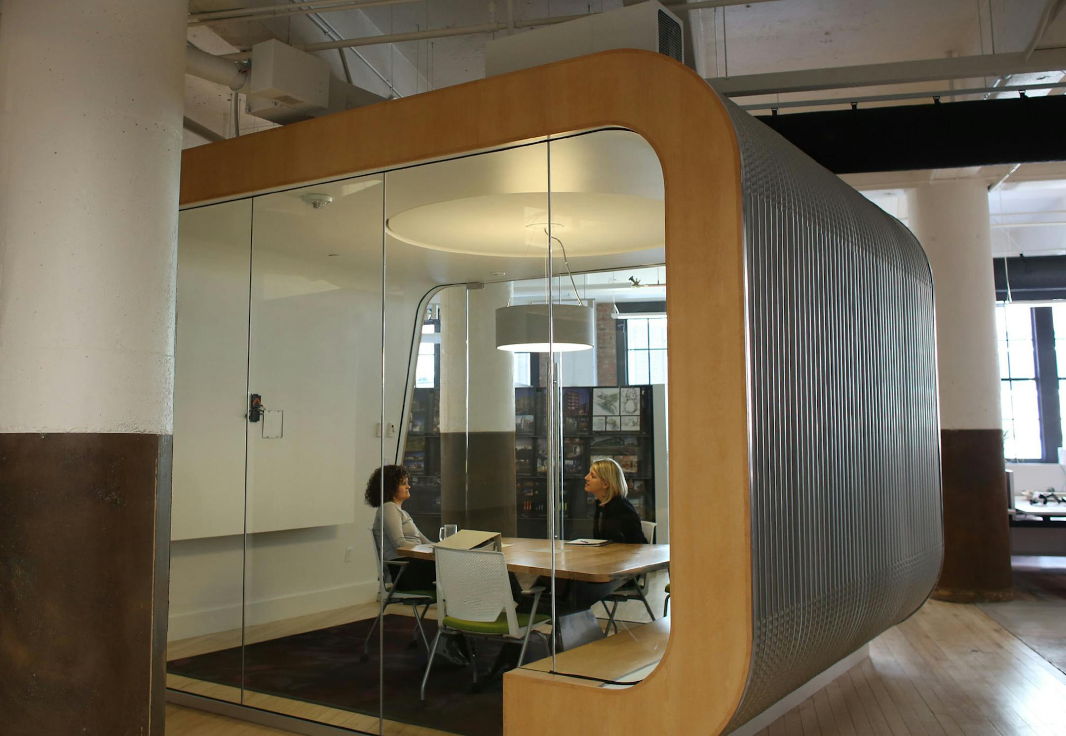 Annie Ryan, project architect, left, and Marcie Weslock, civil engineering group leader at LHB Architect have a meeting in one of their glassed in spaces sof their new office in the North Loop in Minneapolis, Tuesday October 1, 2013. ] (KYNDELL HARKNESS/STAR TRIBUNE) kyndell.harkness@startribune.comAnnie Ryan, project architect, left, and Marcie Weslock, civil engineering group leader at LHB Architect have a meeting in one of their glassed in spaces of their new office in the North Loop in Minne