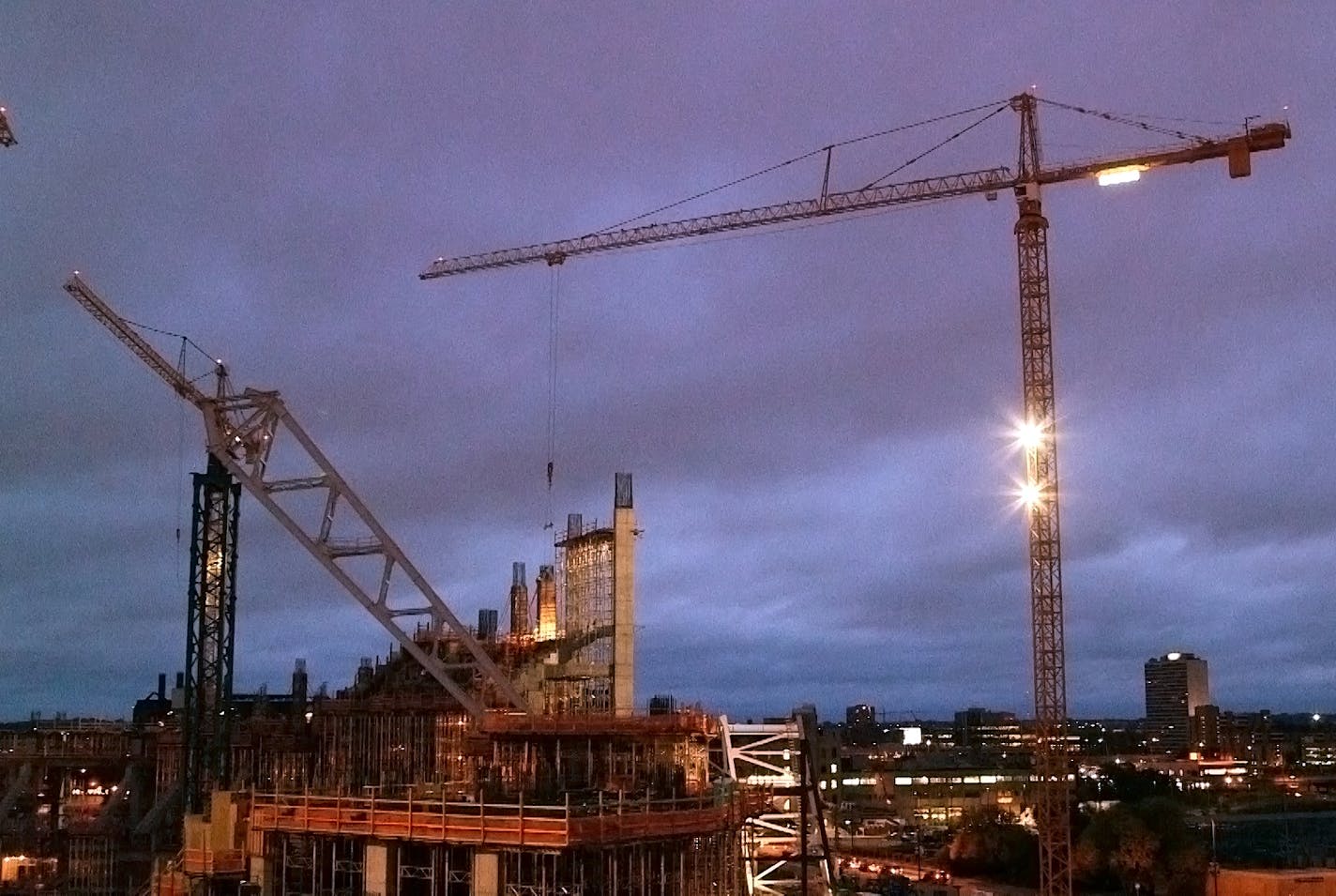 Five tower cranes perch over the new Vikings stadium site. Crane operators ascend the crane in the morning and don&#x201a;&#xc4;&#xf4;t come down until the day&#x201a;&#xc4;&#xf4;s job is done - sometimes 10 or 12 hours later. Friday, Oct. 3, 2014. Minneapolis, Minn.