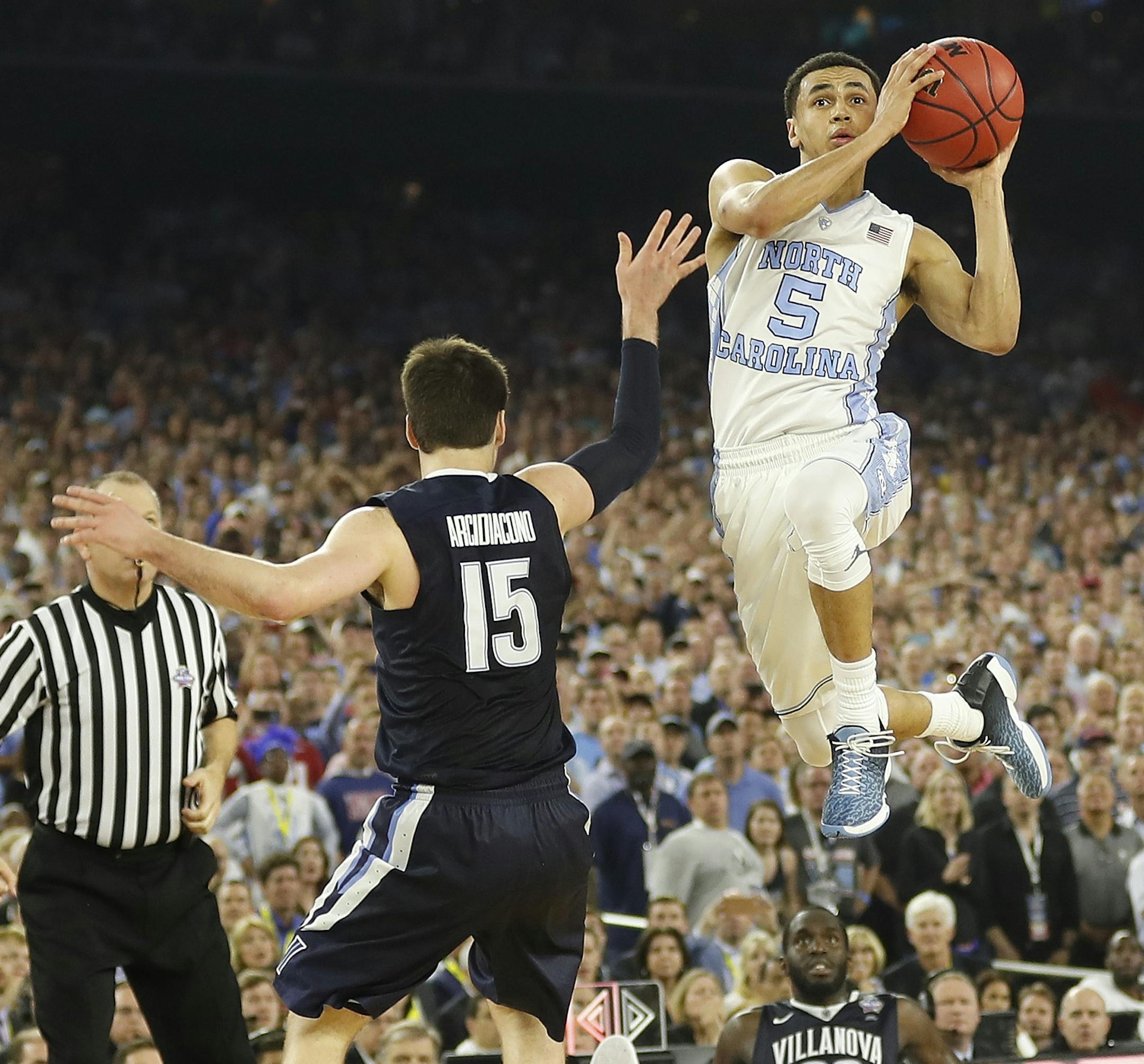 North Carolina guard Marcus Paige (5) shoots over Villanova guard Ryan Arcidiacono (15) during the second half of the NCAA Final Four tournament college basketball championship game Monday, April 4, 2016, in Houston. (AP Photo/David J. Phillip)