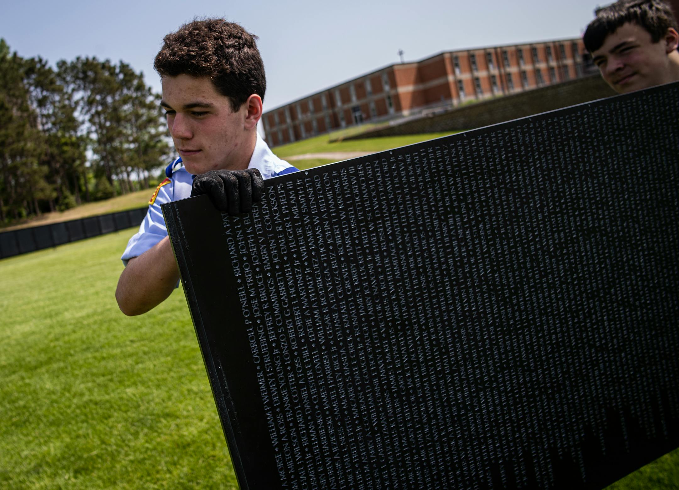 St. Thomas Academy cadets including, Will Paper and Adam Remick, help carry part of the a 3/4 scale of the Wall That Heals that contains 58,281 names of Vietnam Veterans who died.