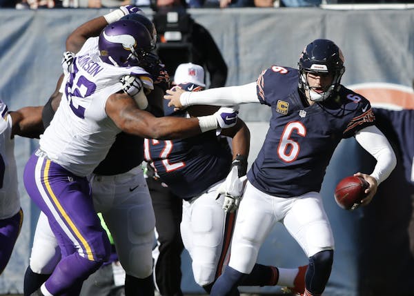 The Bears&#x2019; Jay Cutler escaped the pressure from Vikings tackle Tom Johnson, left, during the Vikings&#x2019; 23-20 win earlier this season.