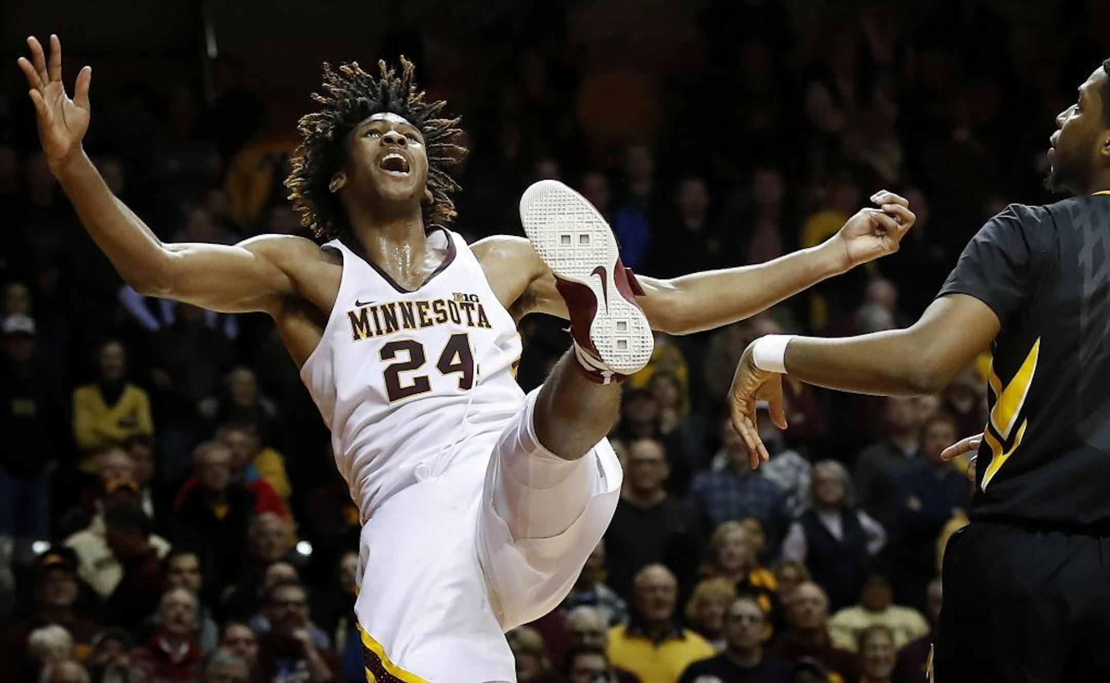 Gophers forward Eric Curry (24) was fouled by Iowa's Isaiah Moss in the second overtime Wednesday night at Williams Arena.