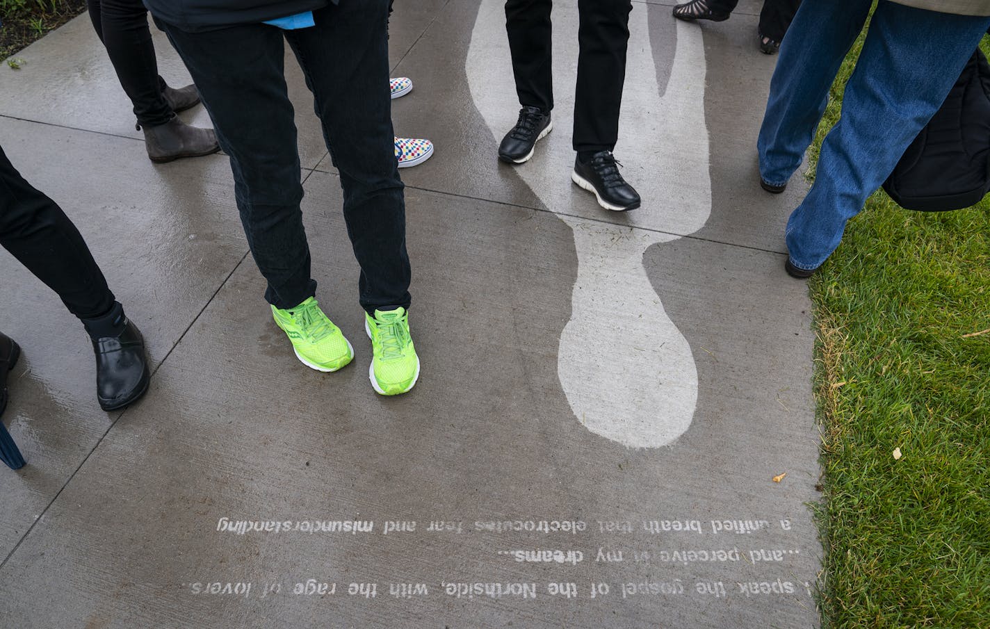 People explore the piece "Kirk Washington, Jr." which only reveals itself when it rains, from the series "Shadows at the Crossroads" during the public unveiling. ] LEILA NAVIDI &#x2022; leila.navidi@startribune.com BACKGROUND INFORMATION: The public unveiling event for "Shadows at the Crossroads" a commission by Twin Cities&#x2013;based artists Ta-coumba T. Aiken and Seitu Jones at the Minneapolis Sculpture Garden on Thursday, June 20, 2019.