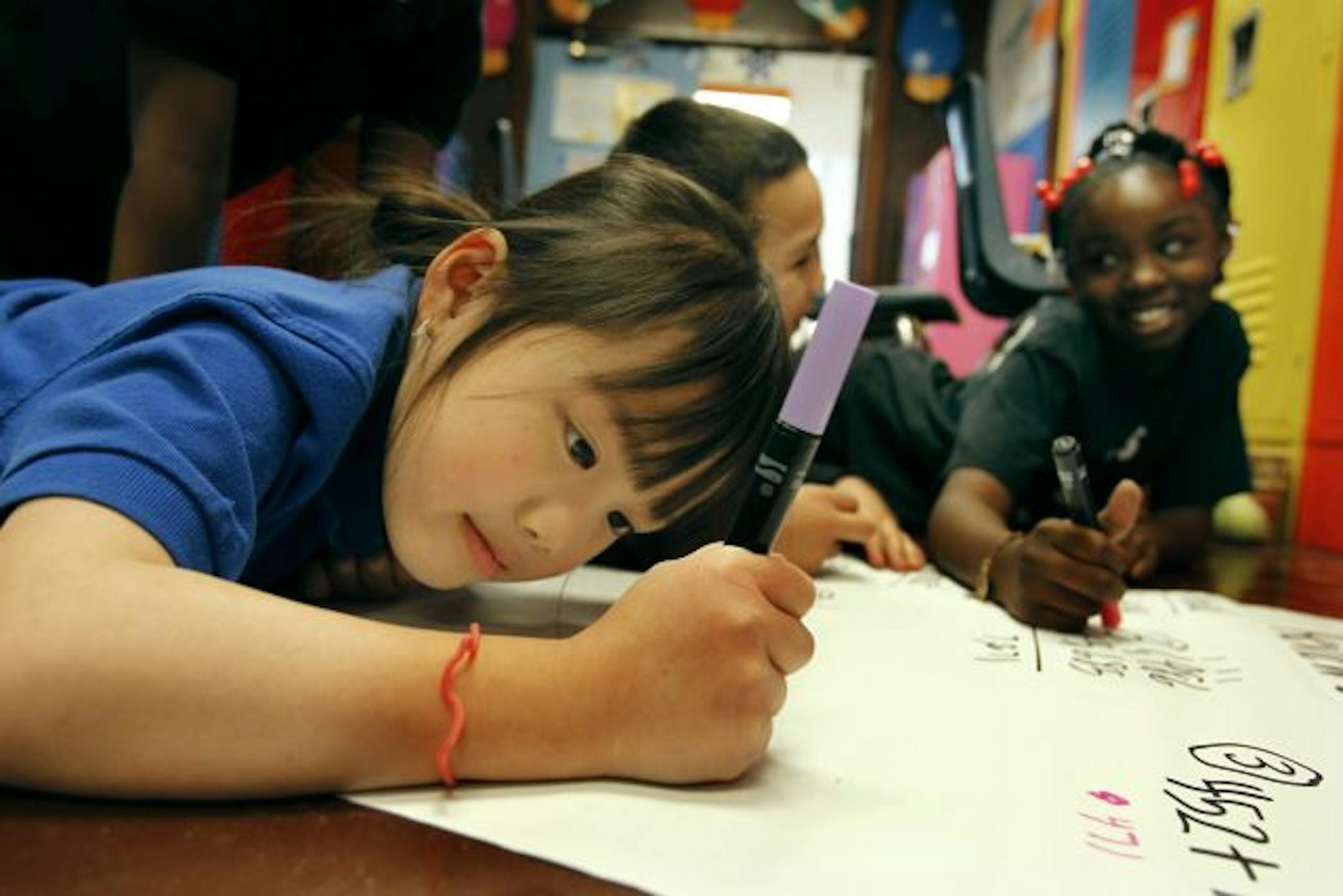 Gao Shang Yang, a third-grader at Concordia Creative Learning Academy in St. Paul, worked on math with her classmates Monday. The school is among those cited by the Minnesota Campaign for Achievement Now (MinnCAN) as models for providing improved chances for student success.