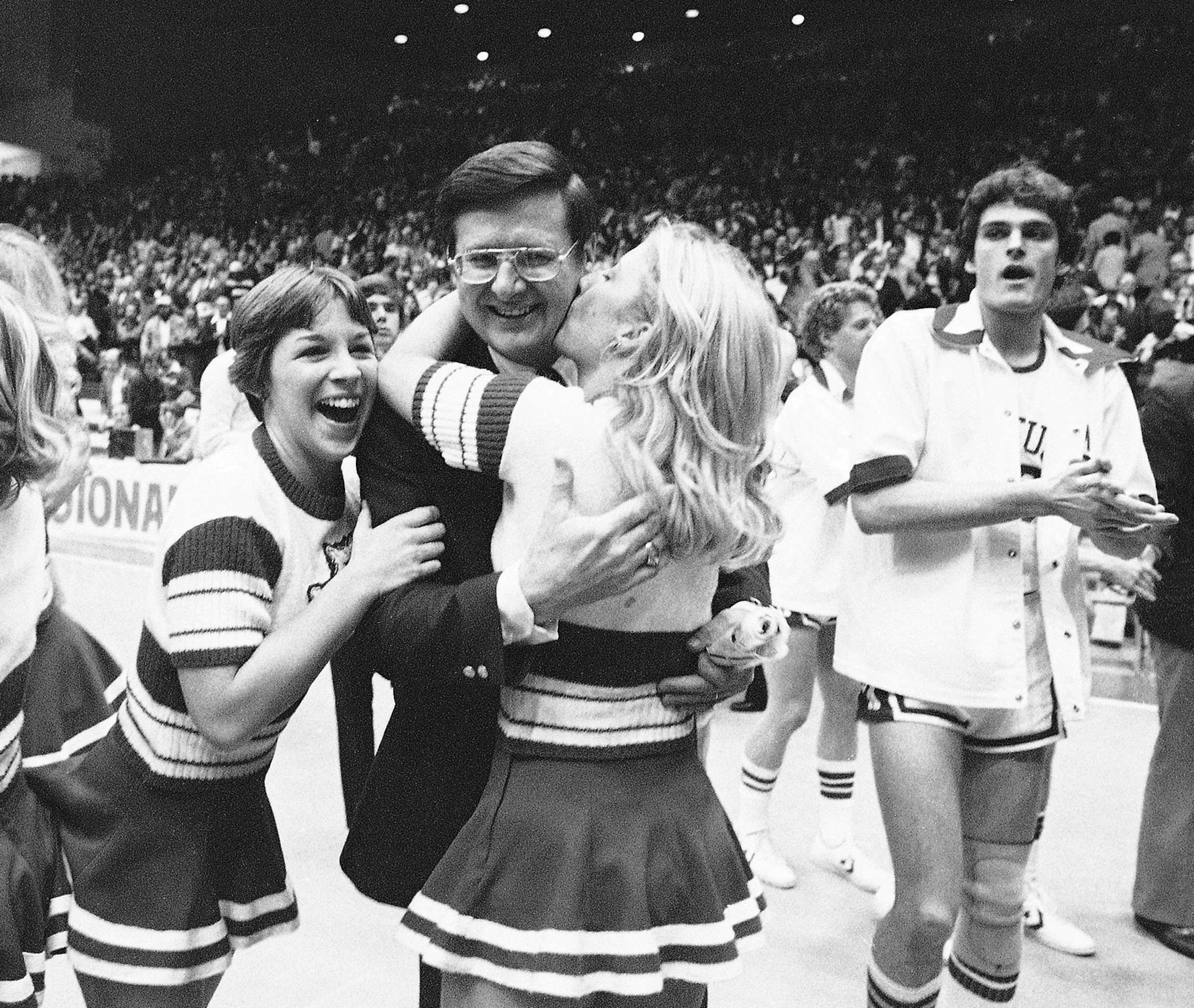 Cheerleaders hug Kentucky head coach Joe Hall after the Wildcats defeated Michigan State in the NCAA Mideast Regionals in Dayton, Ohio, March 18, 1978. The number one rated Wildcats will now move on to the finals in St. Louis. (AP Photo) ORG XMIT: APHS443539