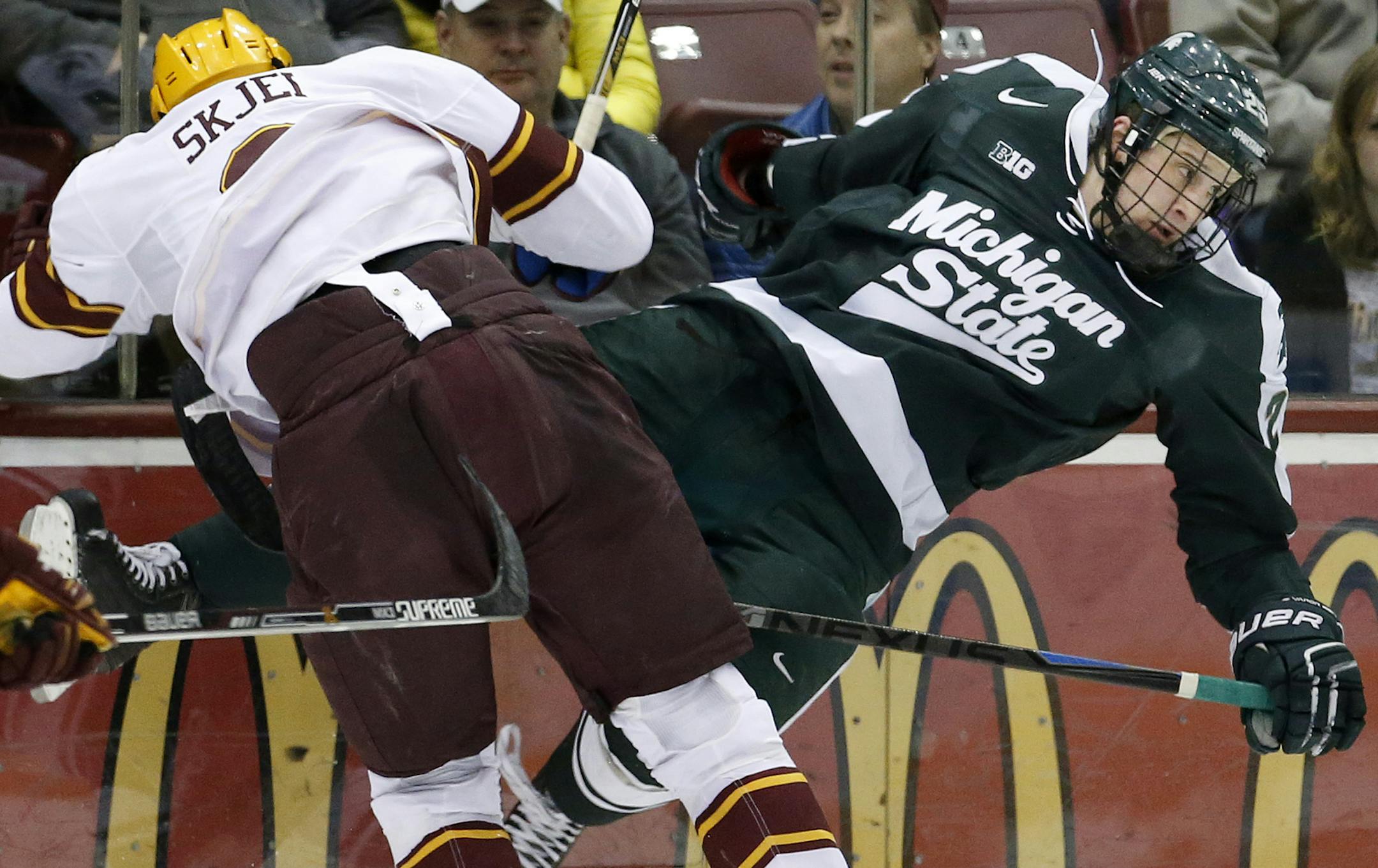 Brady Skjei (2) checked Villiam Haag (26) in the second period. ] CARLOS GONZALEZ cgonzalez@startribune.com, February 26, 2015, Minneapolis, MN, Minneapolis, MN, Mariucci Arena, NCAA Hockey, Big 10, University of Minnesota Gophers vs. Michigan State Spartans