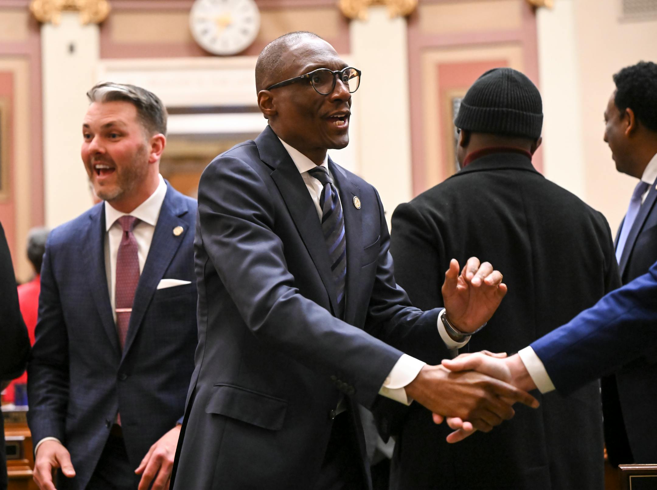 Senate President Bobby Joe Champion (DFL-59) shakes hands as he enters the house chambers before the start of the State of the State address Wednesday night.