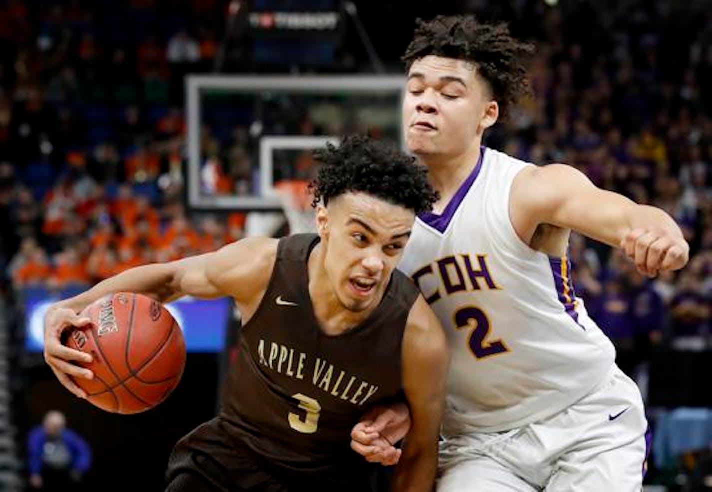 Tre Jones (3) of Apple Valley was defended by Jake Prince (2) Cretin Derham Hall in the second half.