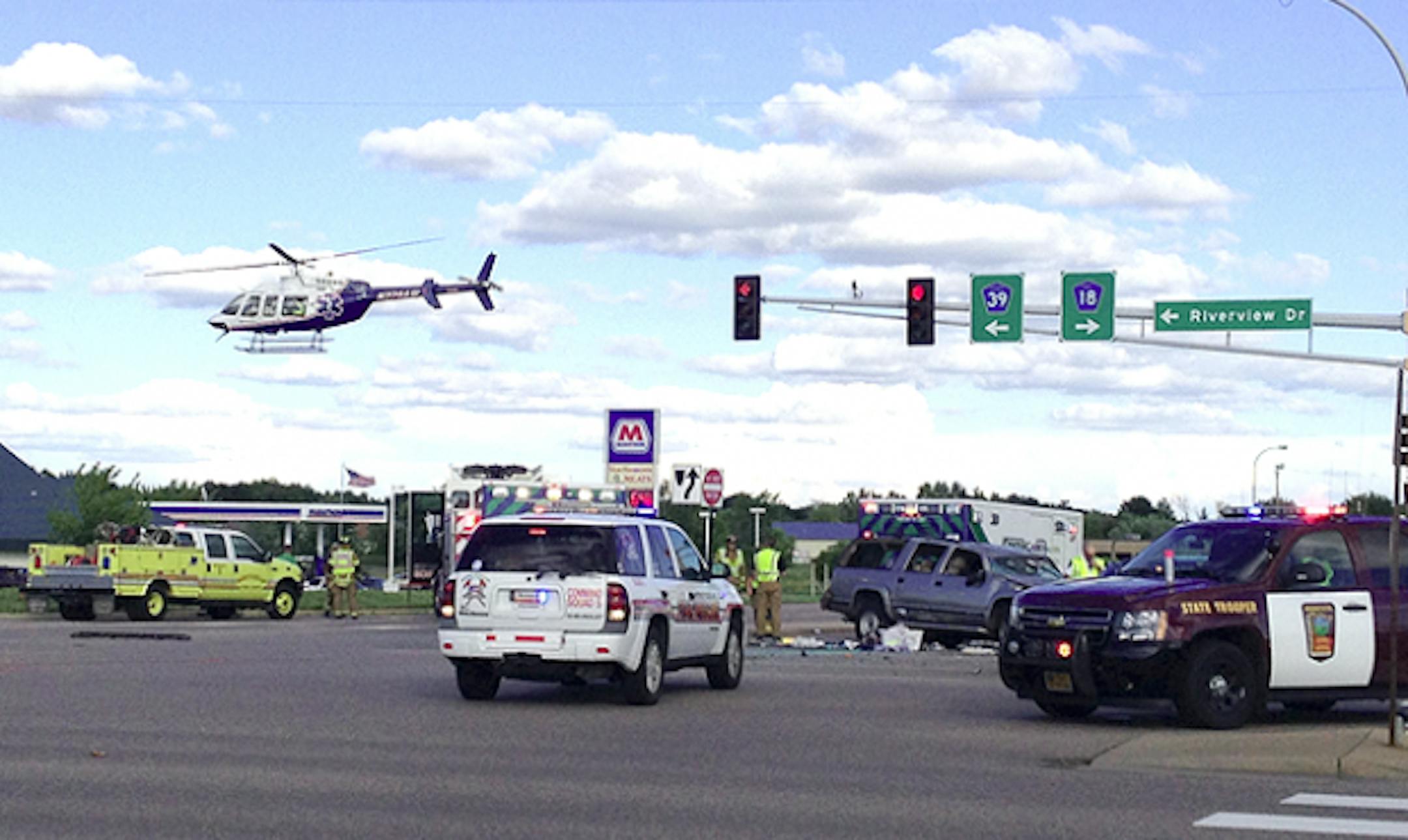 Law enforcement agencies work the scene of Monday's crash that seriously injured a Monticello man and his son.