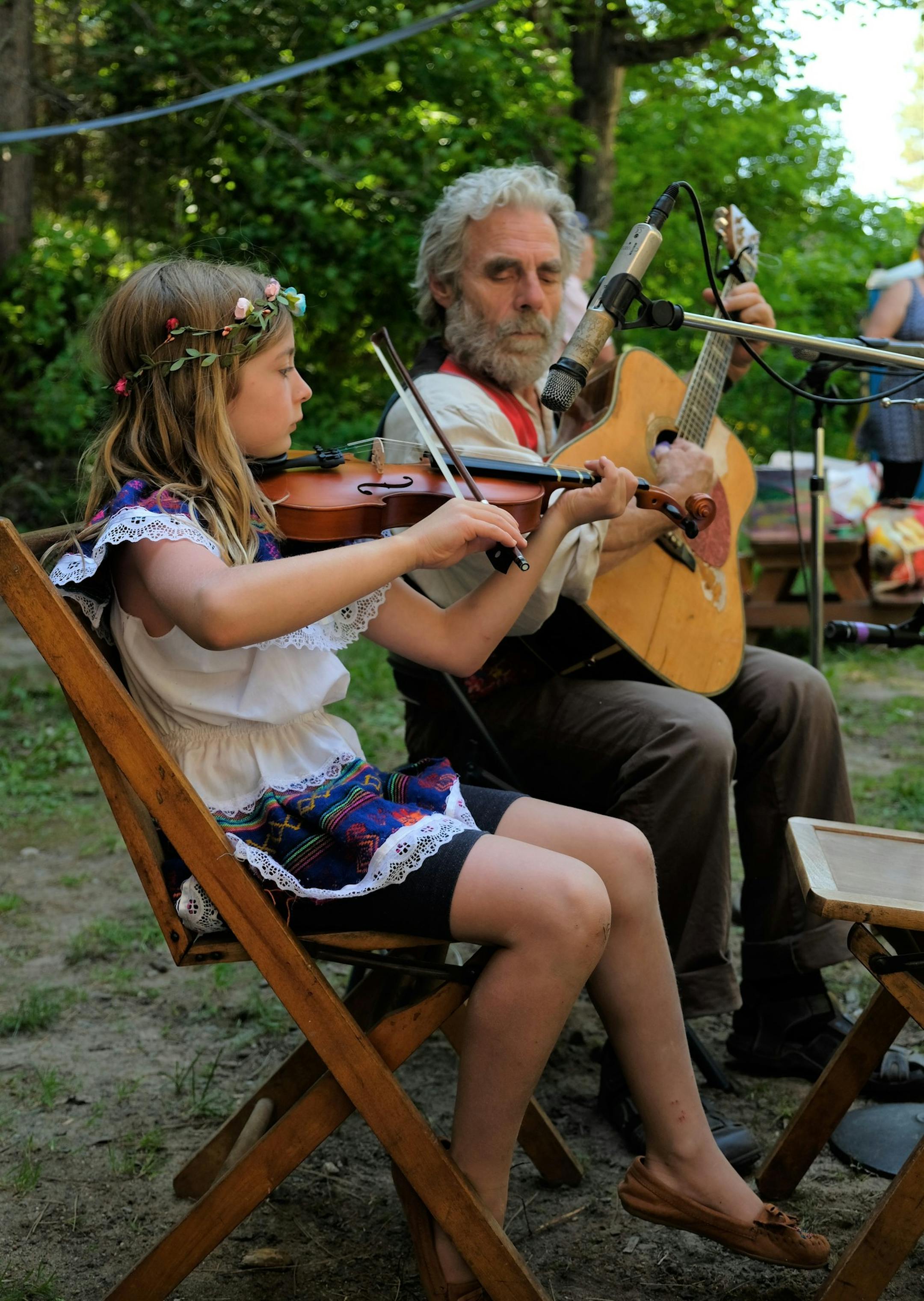 Terrence Smith and Kira Rhodes play music during the Midsummer Festival at Mesaba Co-op Park on Saturday, June 22, 2019 near Hibbing, Minnesota. (Jenna Ross/Star Tribune)