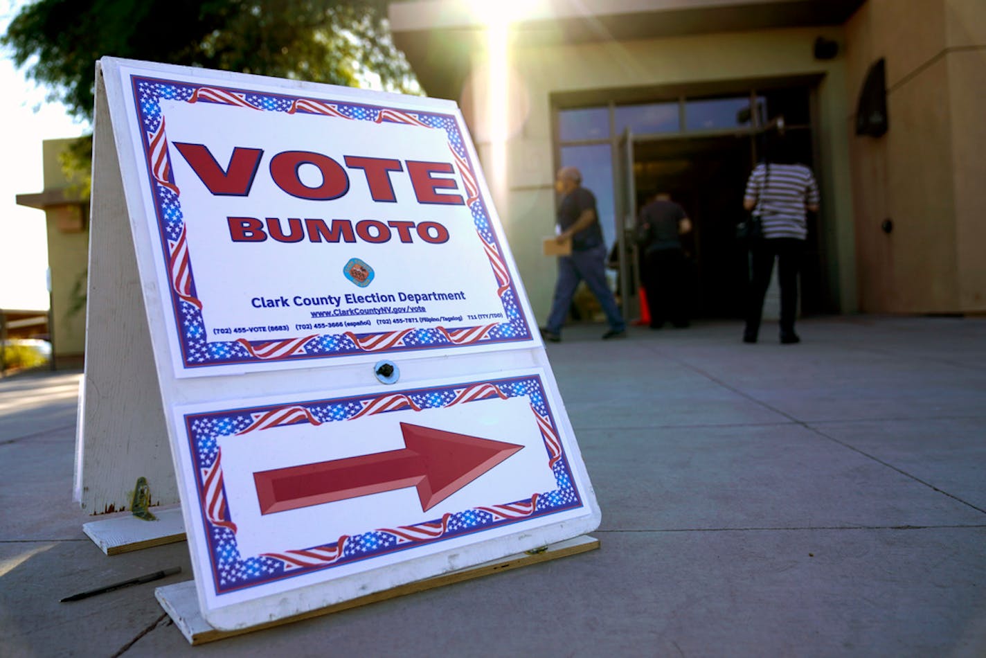 FILE - In this Oct. 30, 2020 file photo a sign directs people where to vote at a polling place during early voting in Las Vegas. Donald "Kirk" Hartle, a Las Vegas businessman, is facing criminal charges of voting twice in the November 2020 election, including with his dead wife's ballot, Nevada state Attorney General Aaron Ford announced Thursday, Oct. 21, 2021. (AP Photo/John Locher,File)