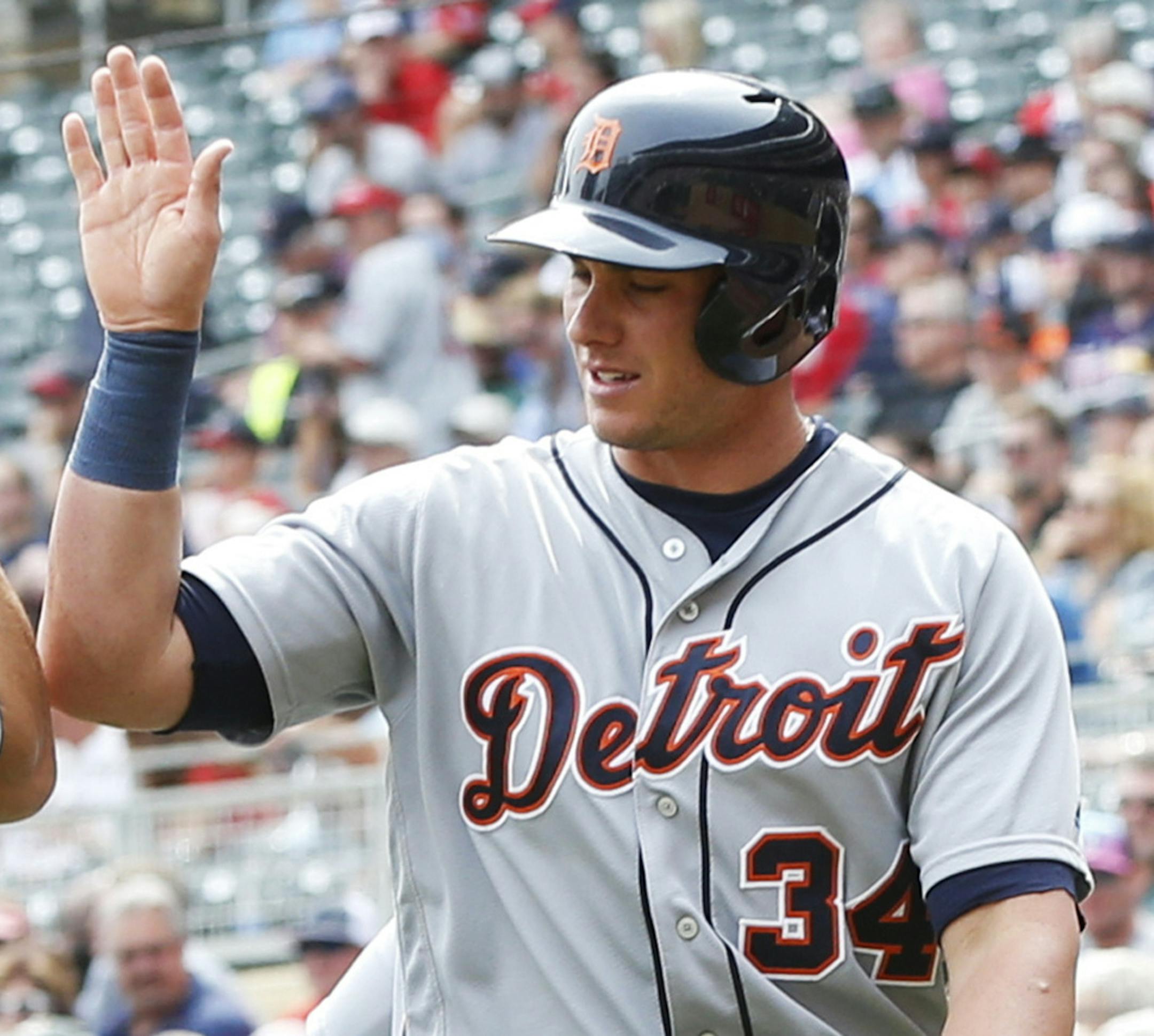 Detroit Tigers' James McCann right, high-fives with Tyler Collins after McCann scored on a two-run double by Ian Kinsler off Minnesota Twins pitcher Jose Berrios in the second inning of a baseball game Thursday, Aug. 25, 2016, in Minneapolis. (AP Photo/Jim Mone)