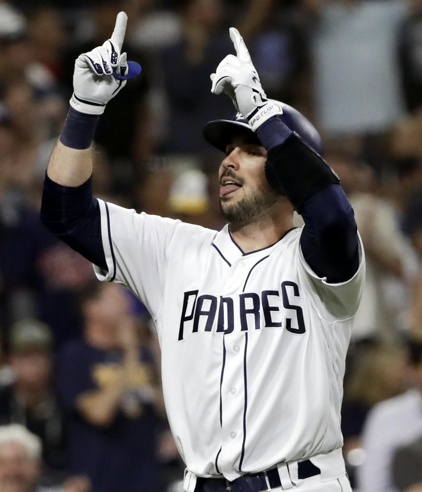 San Diego Padres' Austin Hedges, left, celebrates after hitting two-run home run as teammate Hunter Renfroe, right, follows during the eighth inning of a baseball game against the Minnesota Twins on Tuesday, Aug. 1, 2017, in San Diego. (AP Photo/Gregory Bull)