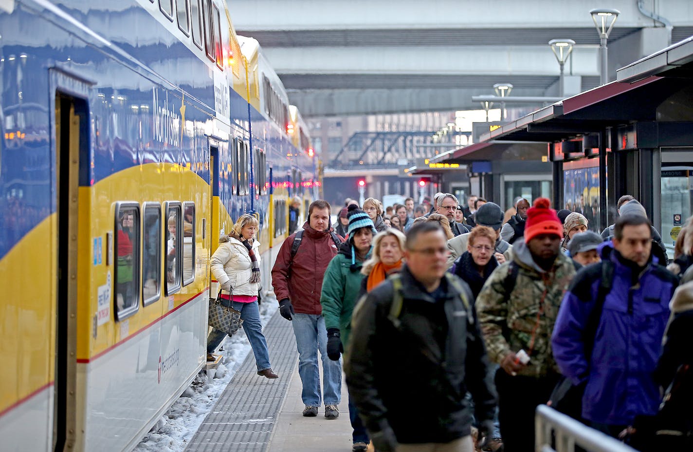 Northstar Passengers made their way off the train early Friday, November 14, 2014 at the Target Field Station in Minneapolis, MN. Five years in, the state's first commuter rail line has seen ridership and its on-time ratings slip due to chronic delays as Northstar competes for track time with oil trains and other freight traffic. Northstar, which links the Hwy 10 corridor to downtown Minneapolis, cost $320 million to build. Last year it averaged 2,783 weekday boardings each week. ] (ELIZABETH FL