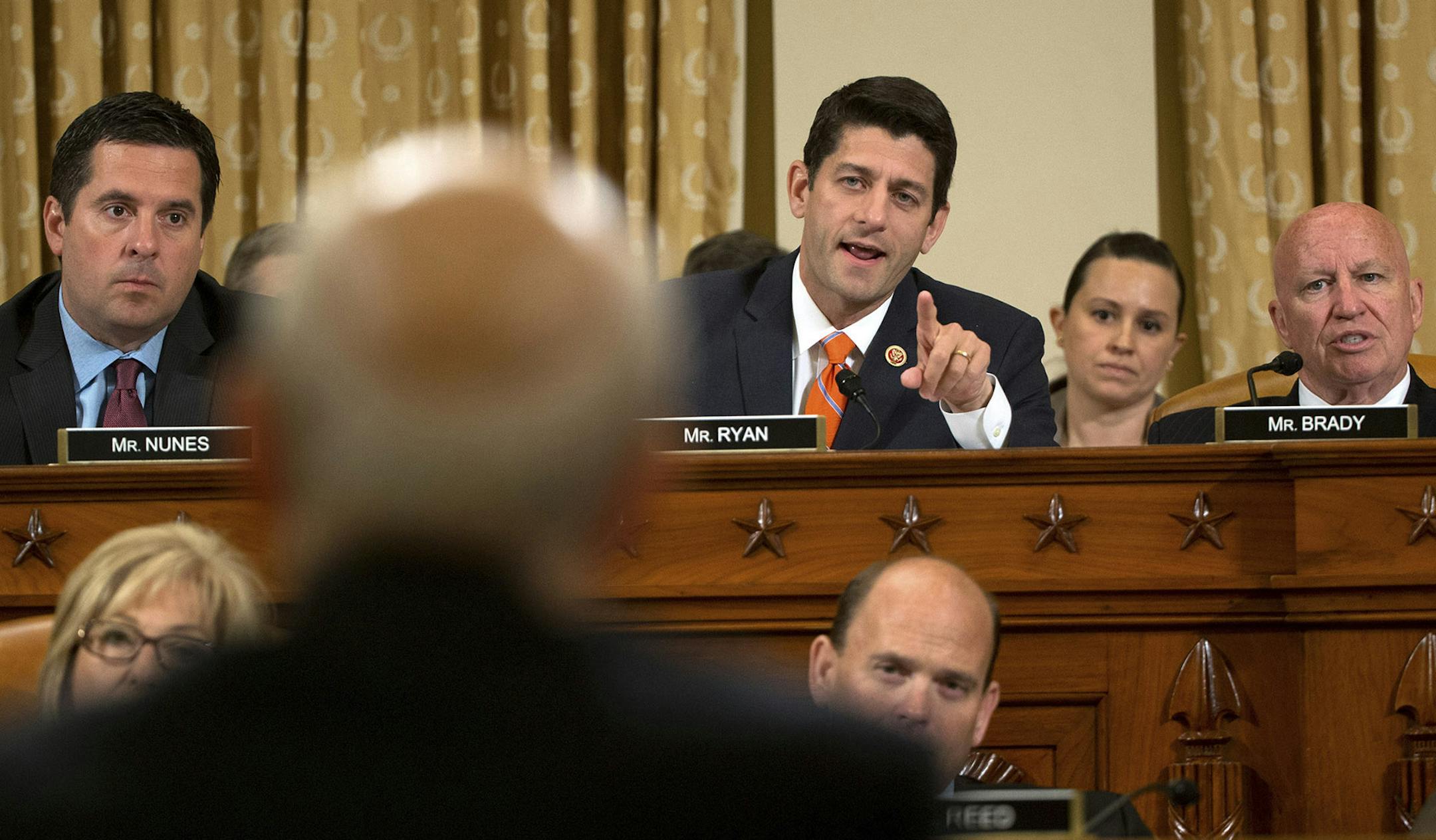 Rep. Paul Ryan (R-Wis.), center, speaks to John Koskinen, commissioner of the Internal Revenue Service, during his testifimony before the House Ways and Means Committee in Washington, June 20, 2014. Koskinen explained on Friday how thousands of IRS emails disappeared, and why that disclosure came more than a year after the start of investigations by the agency into suspected mistreatment of conservative political groups. (Doug Mills/The New York Times) ORG XMIT: MIN2014062411151932