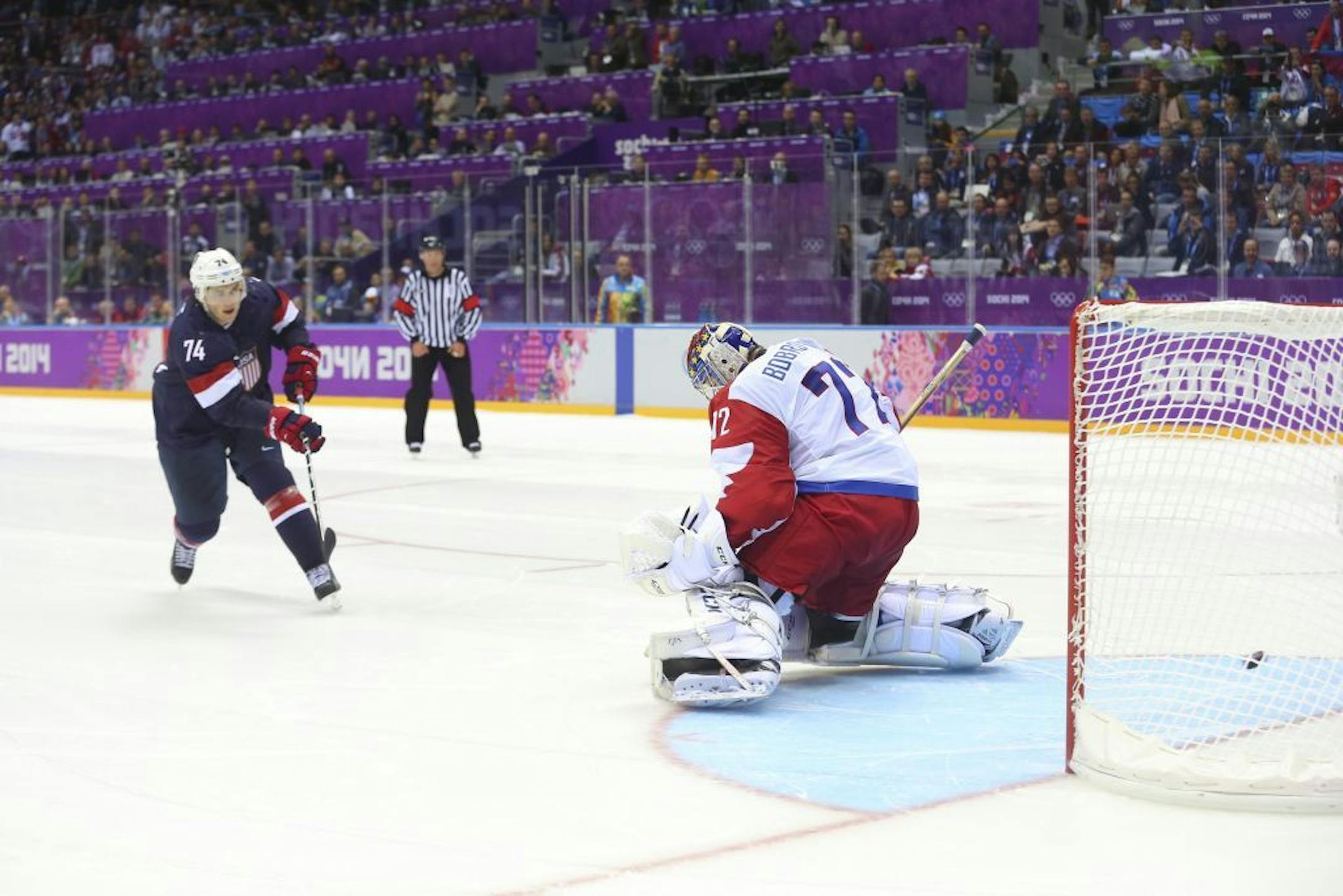 U.S. forward T. J. Oshie (74), left, scores on the shootout after the game was tied 2-2 against Russia during a men's preliminary-round hockey game inside Bolshoy Ice Dome at the 2014 Winter Olympics in Sochi, Russia, Feb. 15, 2014. The U.S. beat Russia 3-2.