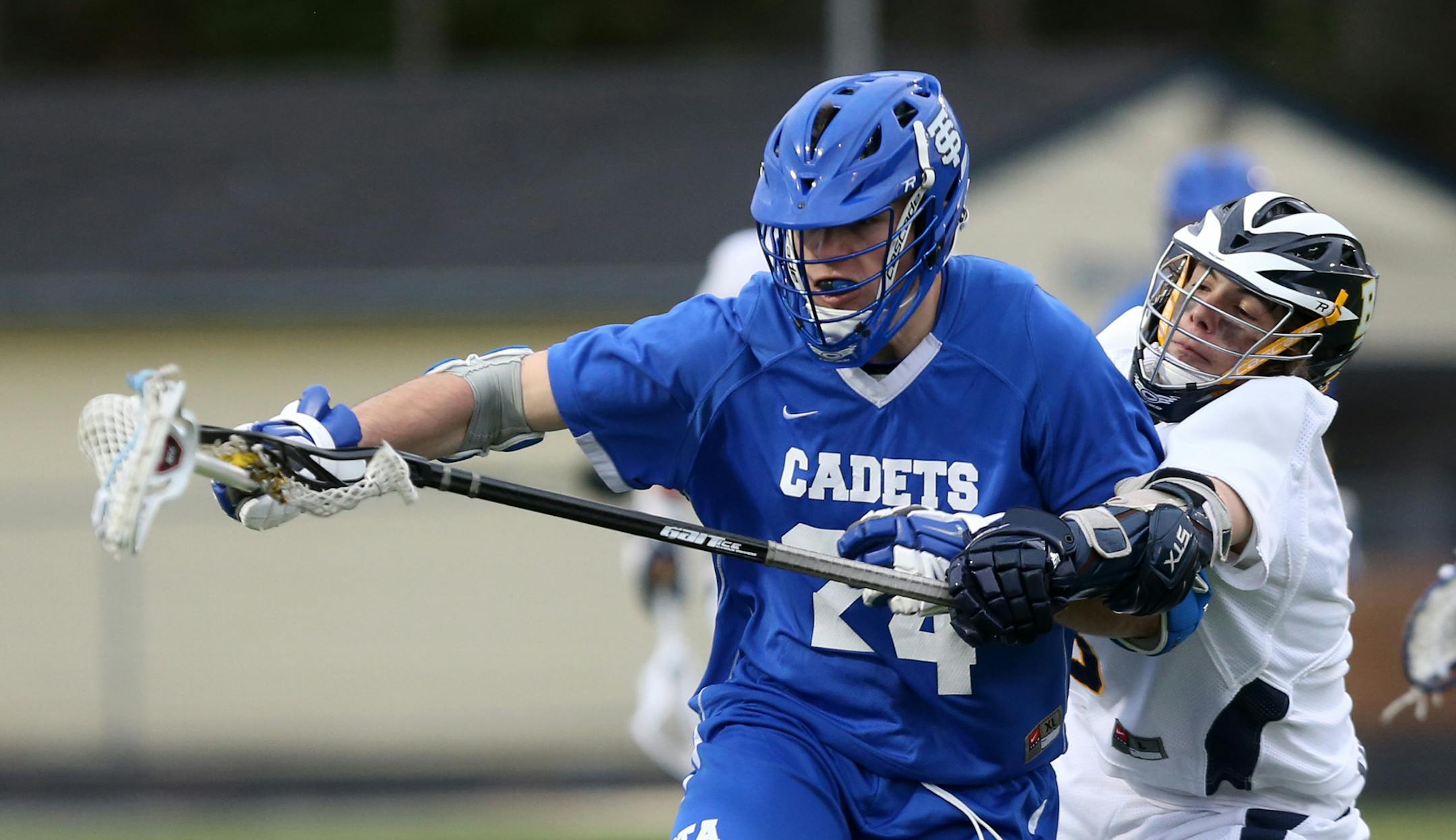 Breck's Austin Heidemann tried to hit the ball away from St. Thomas Academy's Grant Oncay. Lacrosse officials are taking steps to reduce violent collisions amid national concern about concussions in sports.