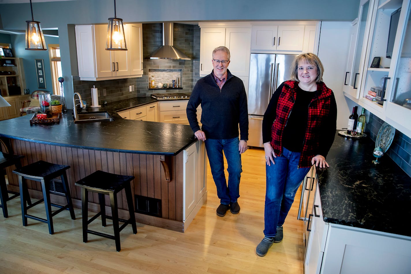 Sue and Mark Read in the newly remodeled kitchen of their Deephaven home. With their children in college, the couple considered a move. Instead, they decided to give their kitchen a fresh new look.