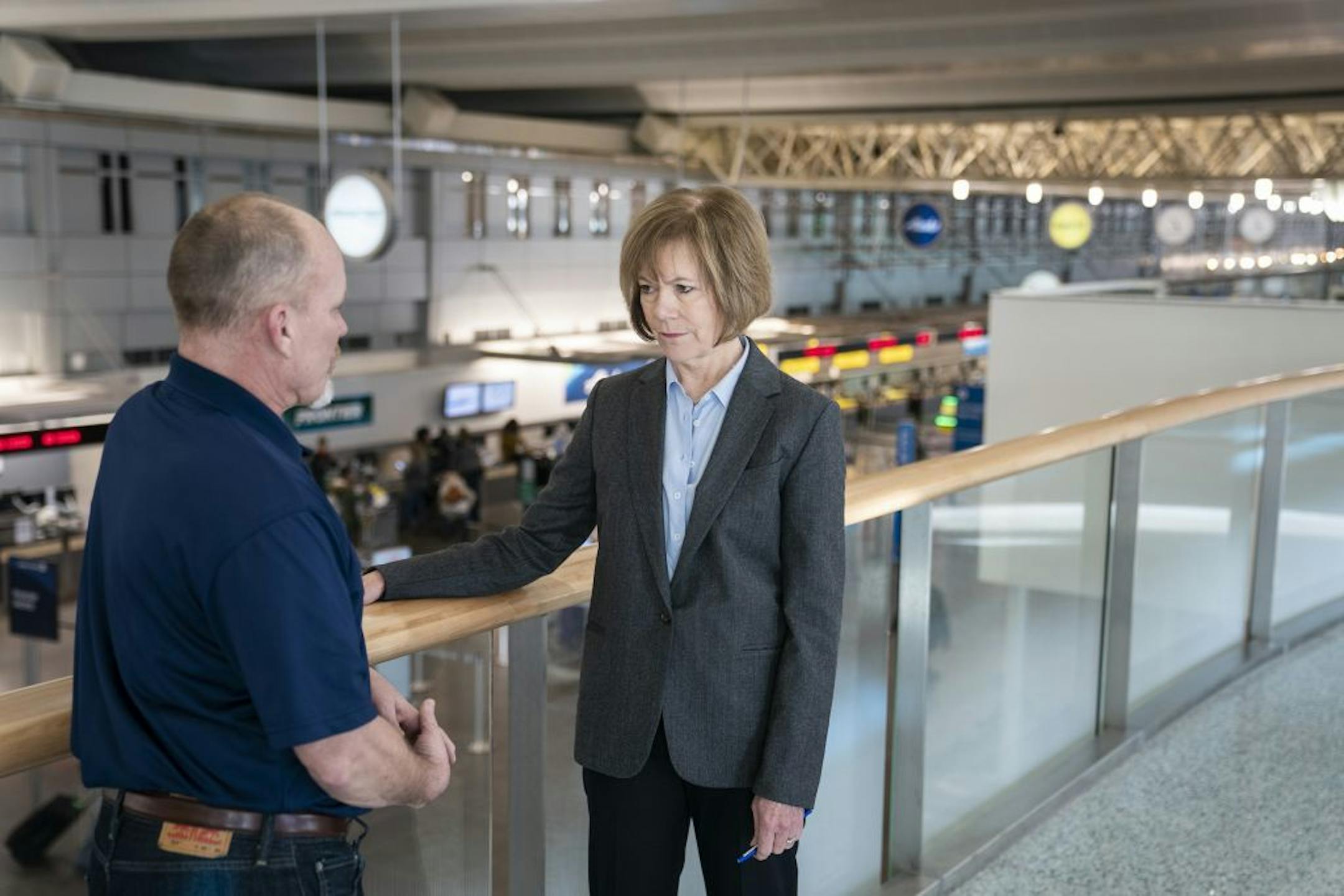 U.S. Sen. Tina Smith (D-Minn.) listens to Gregg James, the national vice president of AFGE District 8, before the news conference.