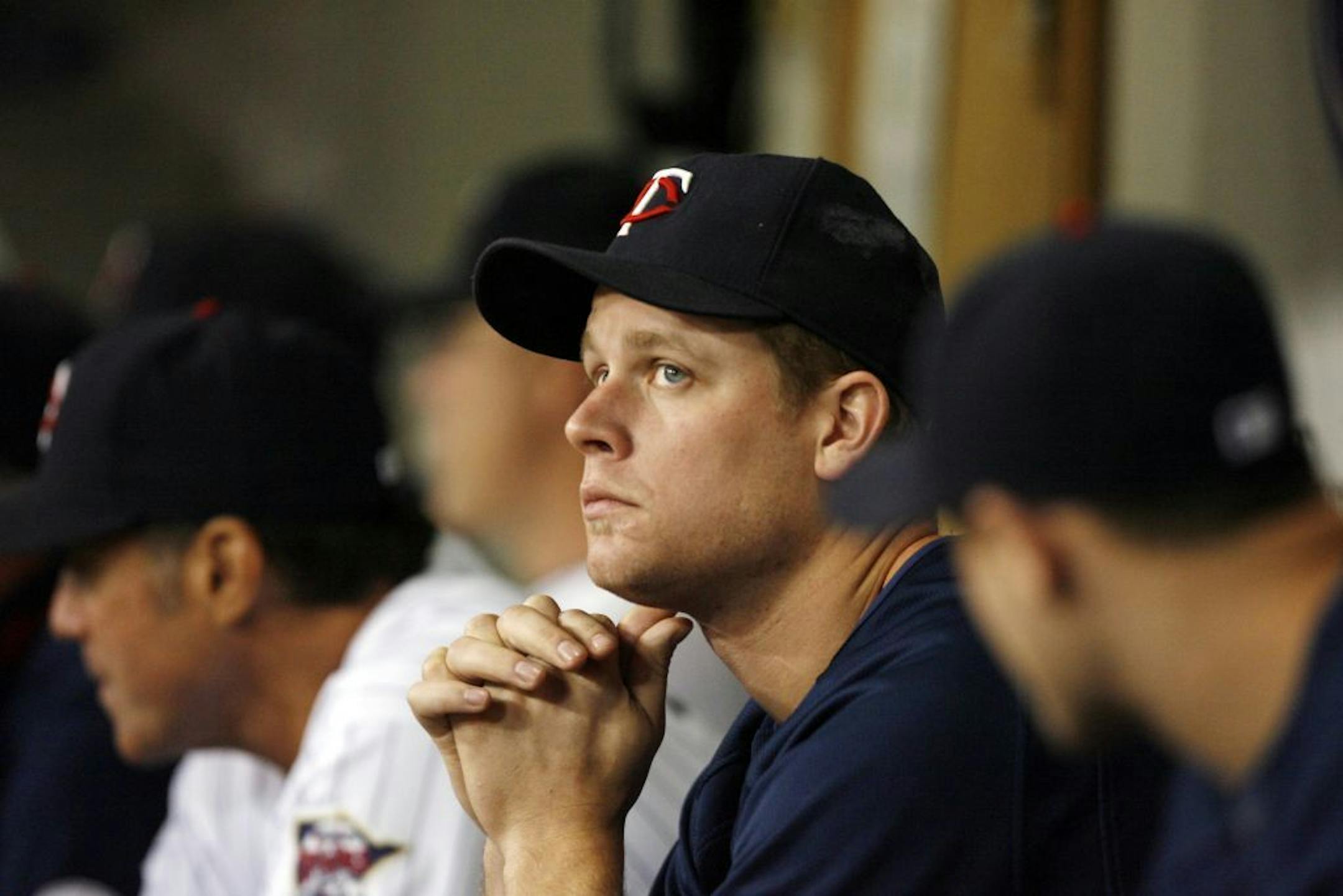 Twins first baseman Justin Morneau watched the game from the dugout during Tuesday night game with the Cleveland Indians. The first baseman is out for the rest of the season because of an injury.