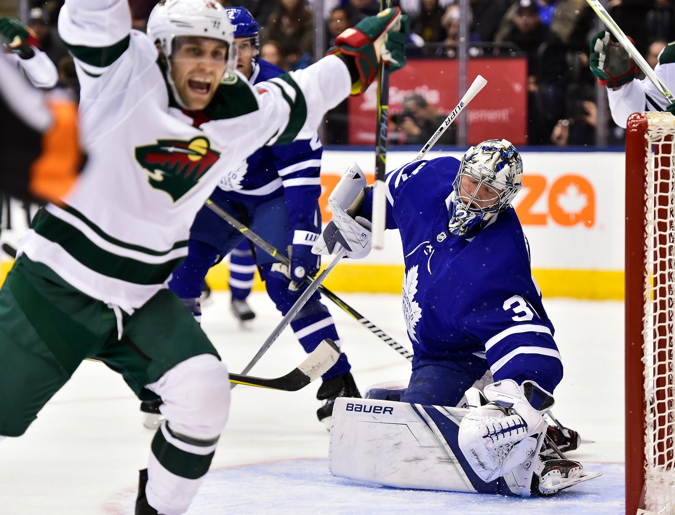 Minnesota Wild left wing Jason Zucker (16) celebrates after scoring on Toronto Maple Leafs goalie Frederik Andersen (31) during the first period of an NHL hockey game Wednesday, Nov. 8, 2017, in Toronto. (Frank Gunn/The Canadian Press via AP)