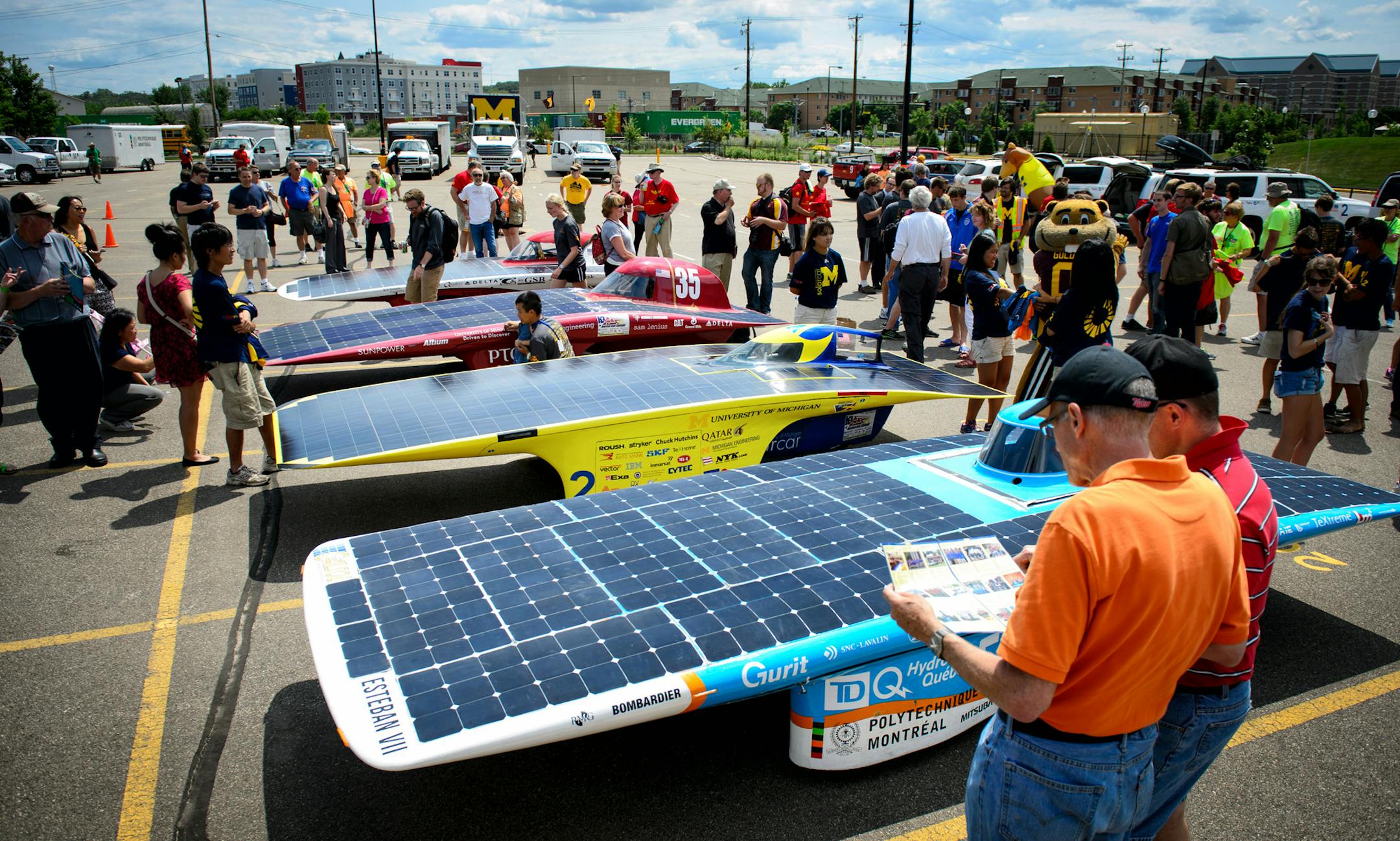 Crowds gathered to look at the first four arriving cars, from left, Iowa State, University of Minnesota, University of Michigan and Polytechnique Montreal. The American Solar Challenge, a solar car race, ended at the finish line at the University of Minnesota East Bank campus. First solar cars Michigan was the first to arrive with the U of Minnesota arriving second. Monday, July 28, 2014. ] GLEN STUBBE * gstubbe@startribune.com