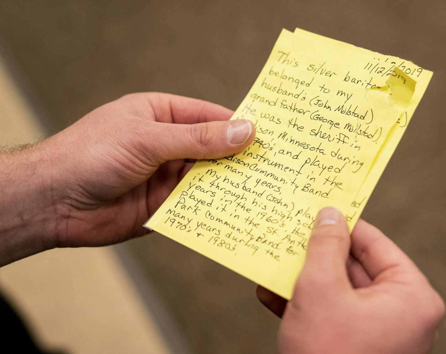 Hmong College Prep Academy band director Roy Pienaar a held a note from the owner of a donated baritone about how it was beloved by her late husband in St. Paul, Minn., on Friday, November 15, 2019. The baritone had been donated through the nonprofit Vega, an organization that collects used band instruments and distributes them to children in need. ] RENEE JONES SCHNEIDER &#xa5; renee.jones@startribune.com