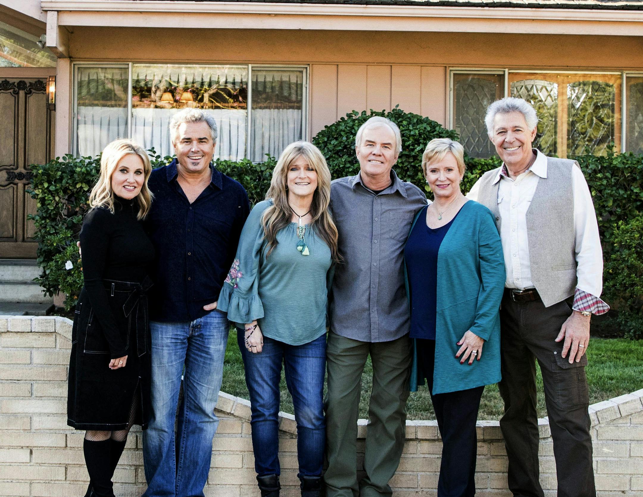 In this Thursday, Nov. 1 2018, photo provided by HGTV, members of the "The Brady Bunch" cast from left to right, Maureen McCormack, Christopher Knight, Susan Olsen, Mike Lookinland, Eve Plumb and Barry Williams pose in front of the original Brady home in the Studio City neighborhood in Los Angeles. The cast members gathered Thursday at the home that was featured in the opening and closing of the sitcom. HGTV purchased the home in the Studio City neighborhood in Los Angeles for its new series, "A