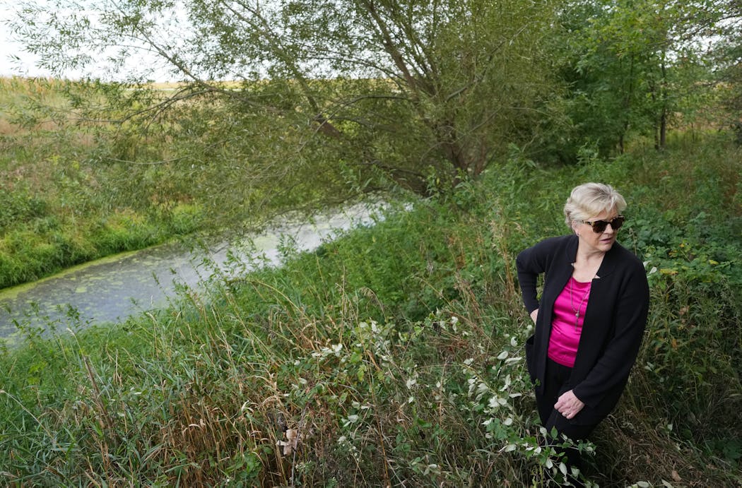 Sonja Trom Eayrs checks out the start of the Cedar River near her family farm in Blooming Prairie, Minn. She’s a member of Dodge County Concerned Citizens, one of the groups suing the U.S. Environmental Protection Agency to try to get tougher rules for the water pollution permits for large livestock farms.