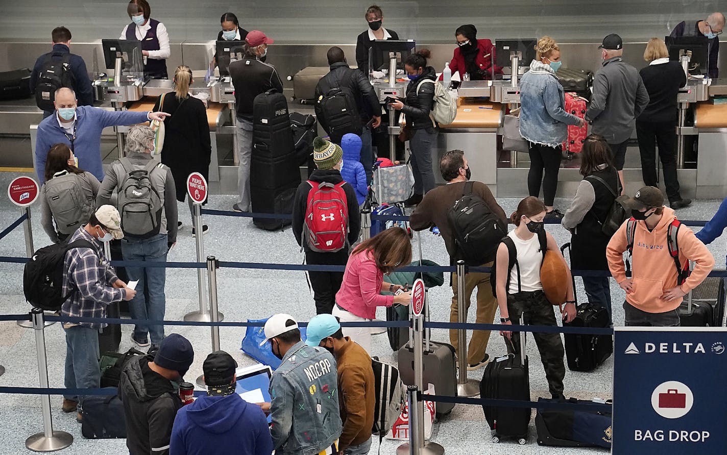 Holiday travelers crowd the ticketing area of terminal one Wednesday at MSP in Minneapolis. Travel experts were predicting Wednesday to be the busiest travel day in the U.S. since the beginning of the coronavirus pandemic earlier in 2020, despite CDC warnings against travel during the Thanksgiving holiday.