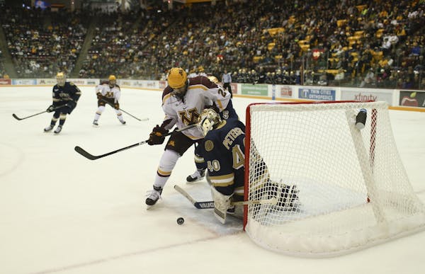 Hudson Fasching went for a rebound after Notre Dame goalie Cal Peterson.