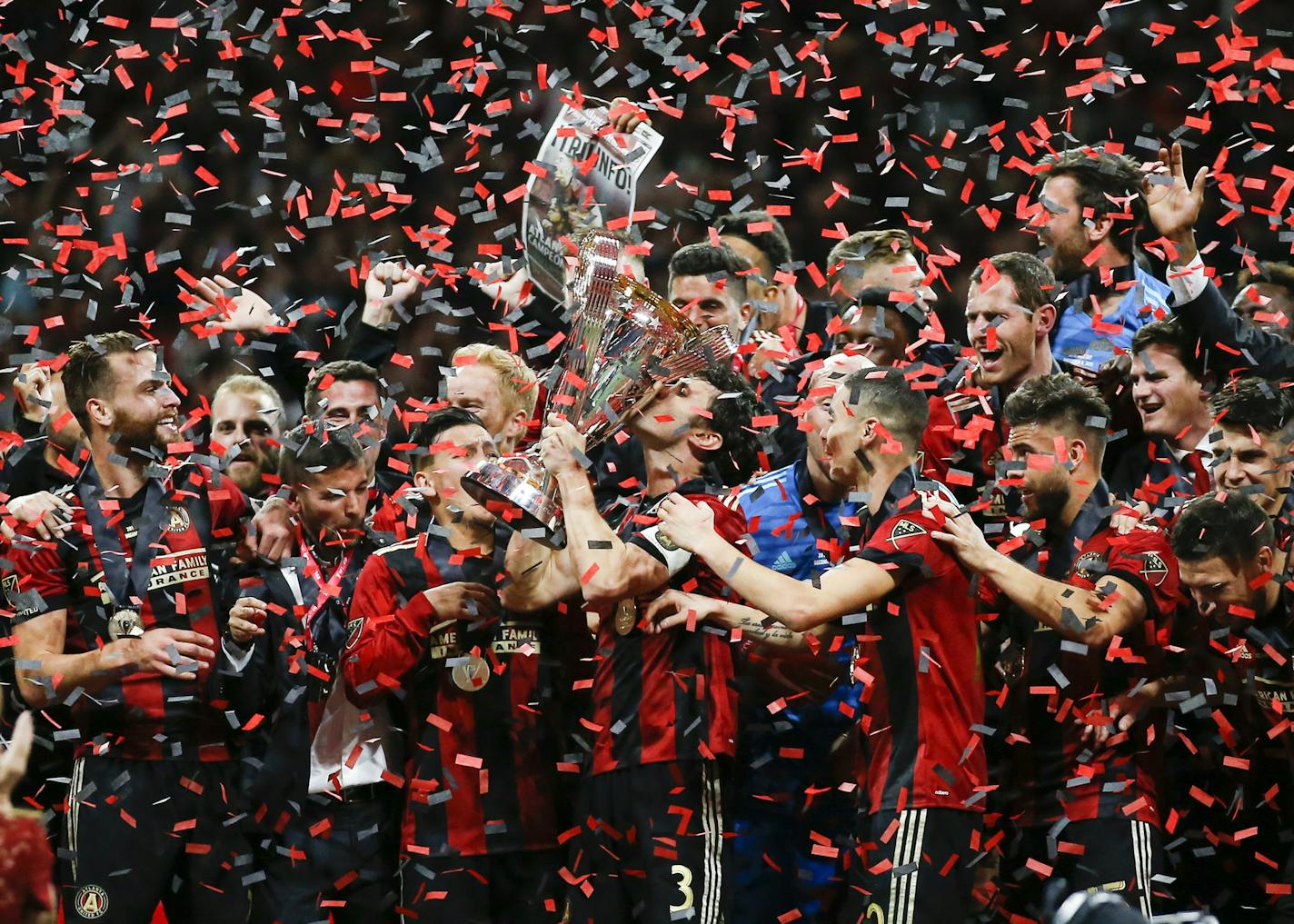 Atlanta United team captain Michael Parkhurst, center, kissed the MLS Cup trophy as teammates celebrate after they defeated the Portland Timbers 2-0 in the MLS Cup championship in December 2018.