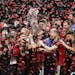 Atlanta United team captain Michael Parkhurst, center, kissed the MLS Cup trophy as teammates celebrate after they defeated the Portland Timbers 2-0 i