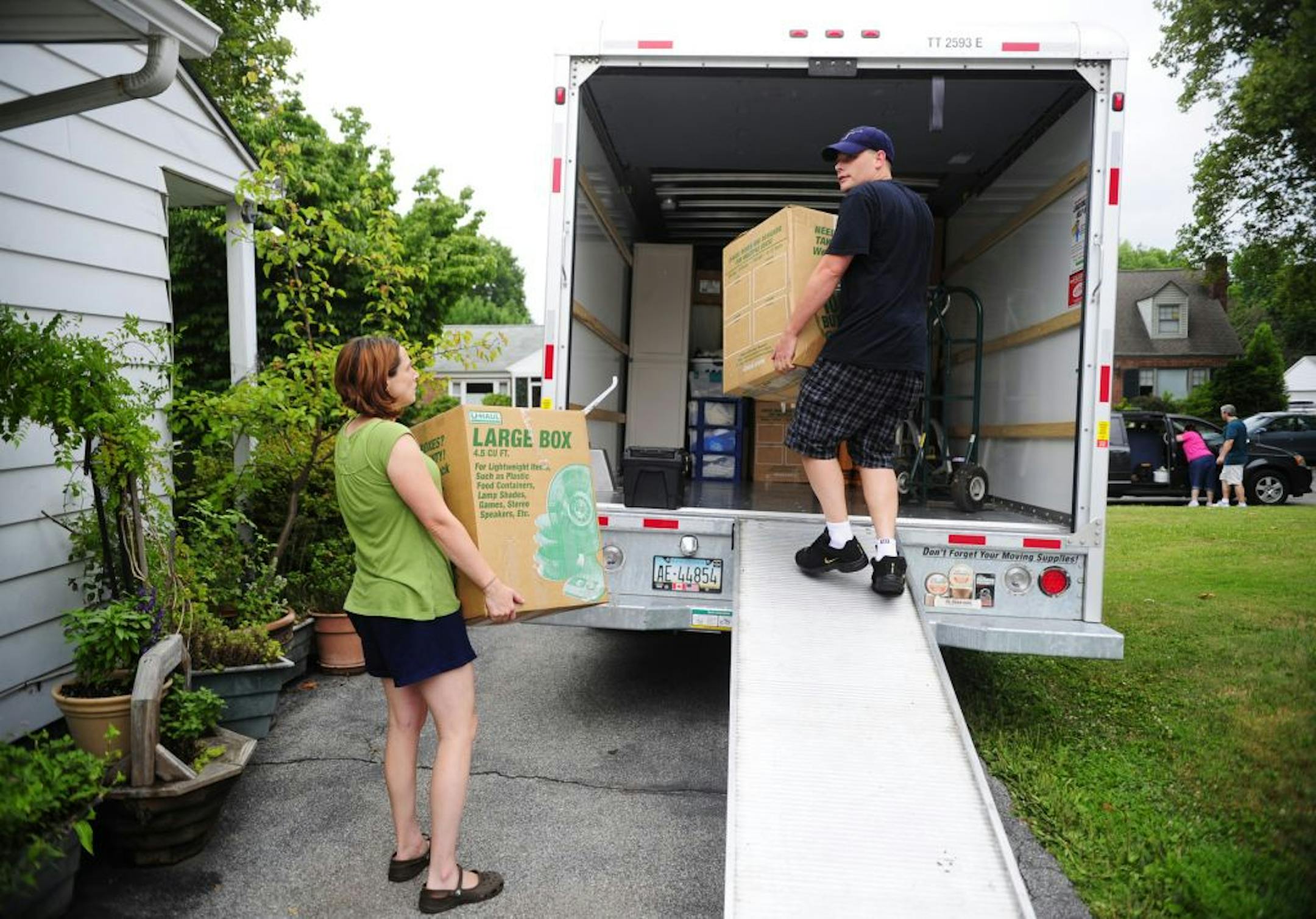 FILE- In this July 13, 2012, file photo, people load a U-Haul truck with boxes while they prepare to move in York, Pa. Many have had to reconsider their living situation because of the pandemic. Before you decide to relocate, make a budget to account for moving costs and the cost of living in your new location.